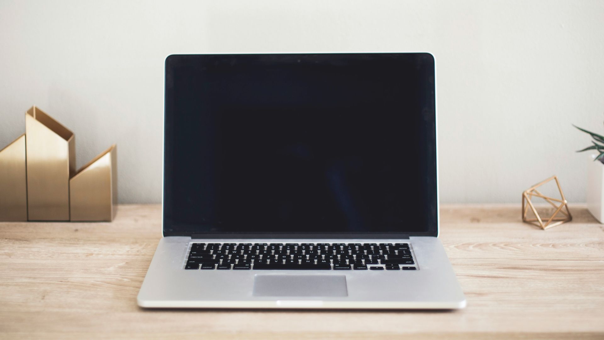 MacBook Pro on top of brown table