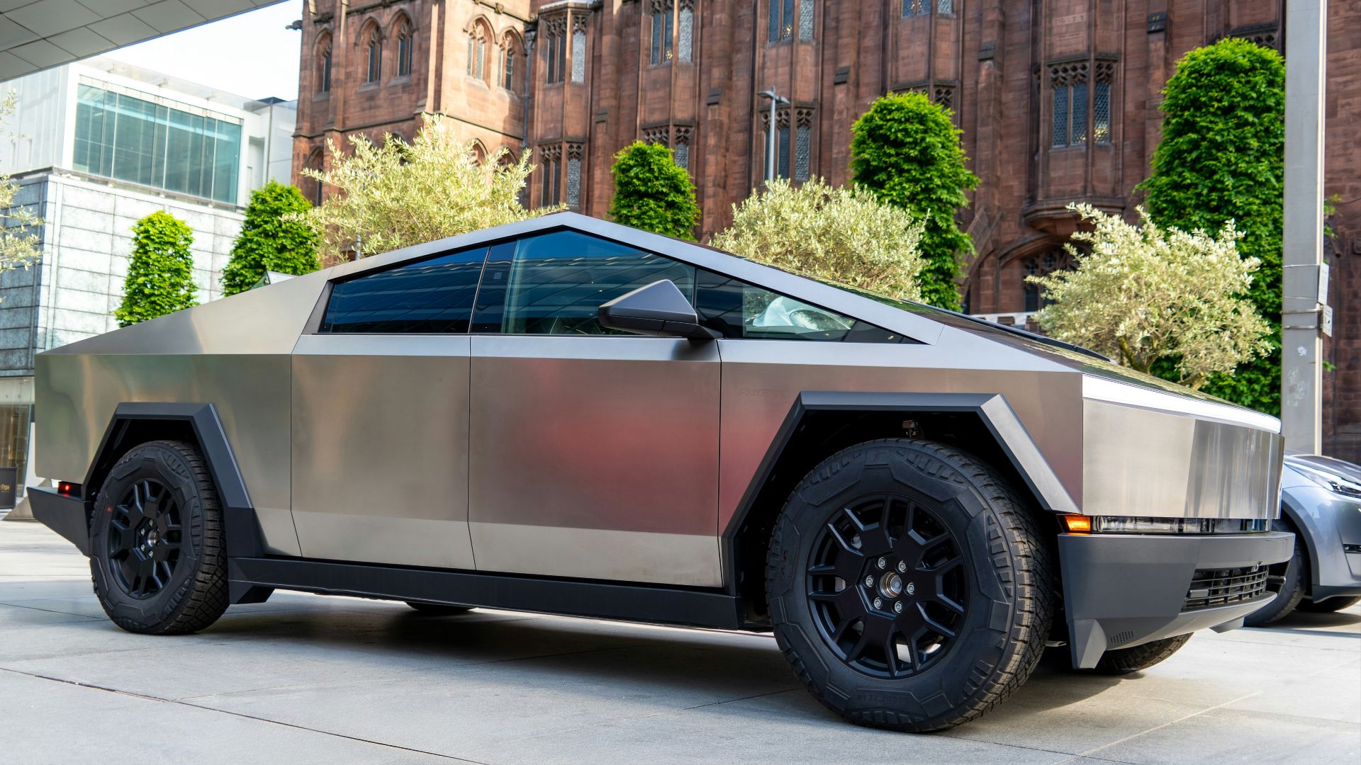 a futuristic car parked in front of a building