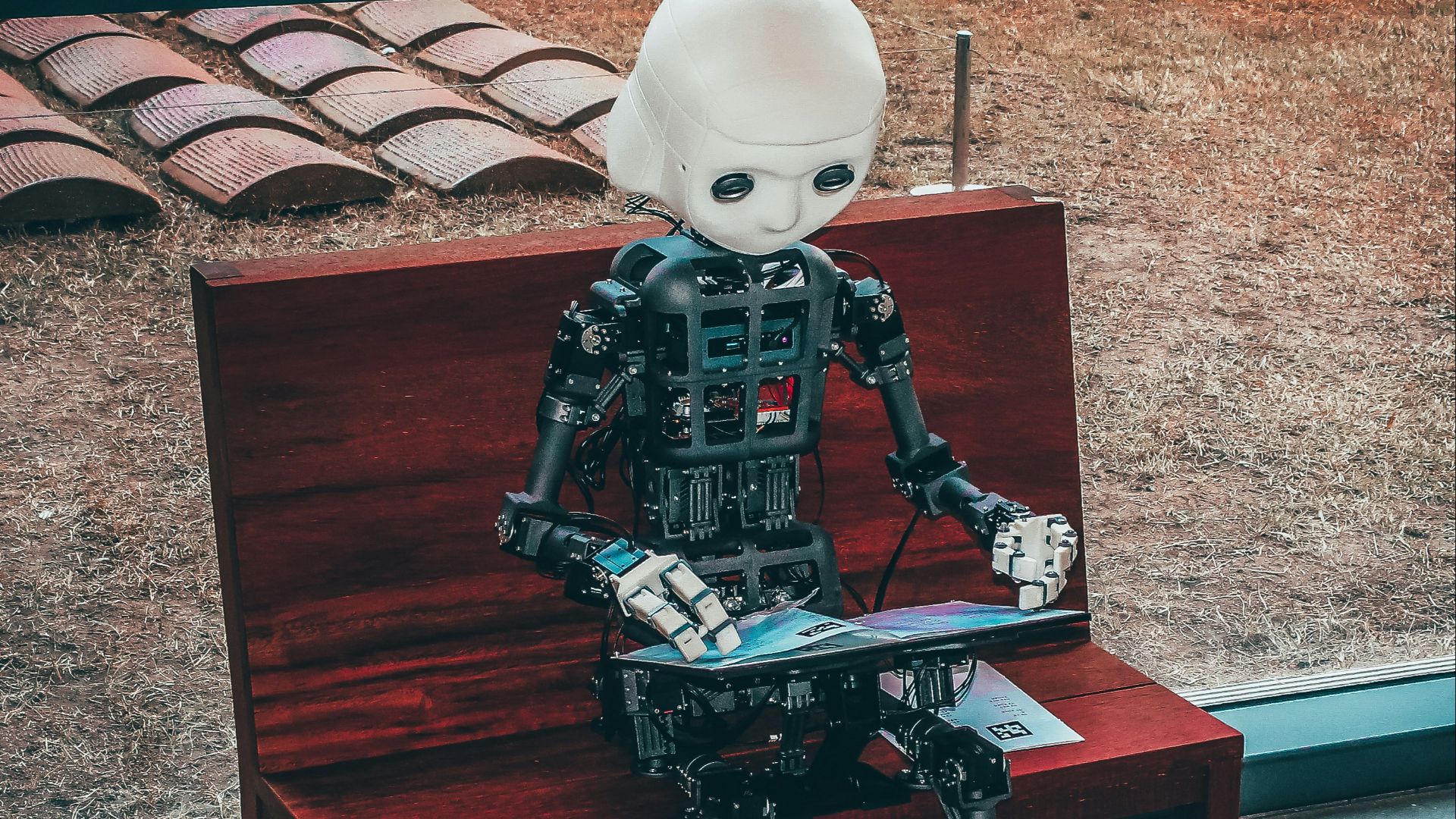 black and white robot toy on red wooden table