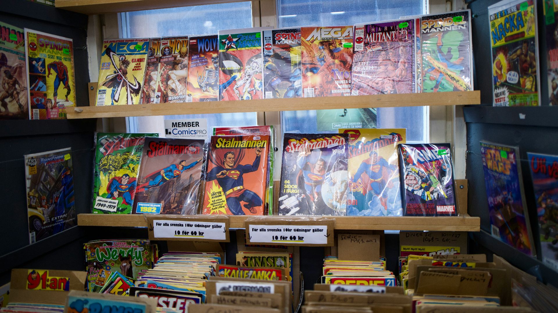 assorted books on brown wooden shelf