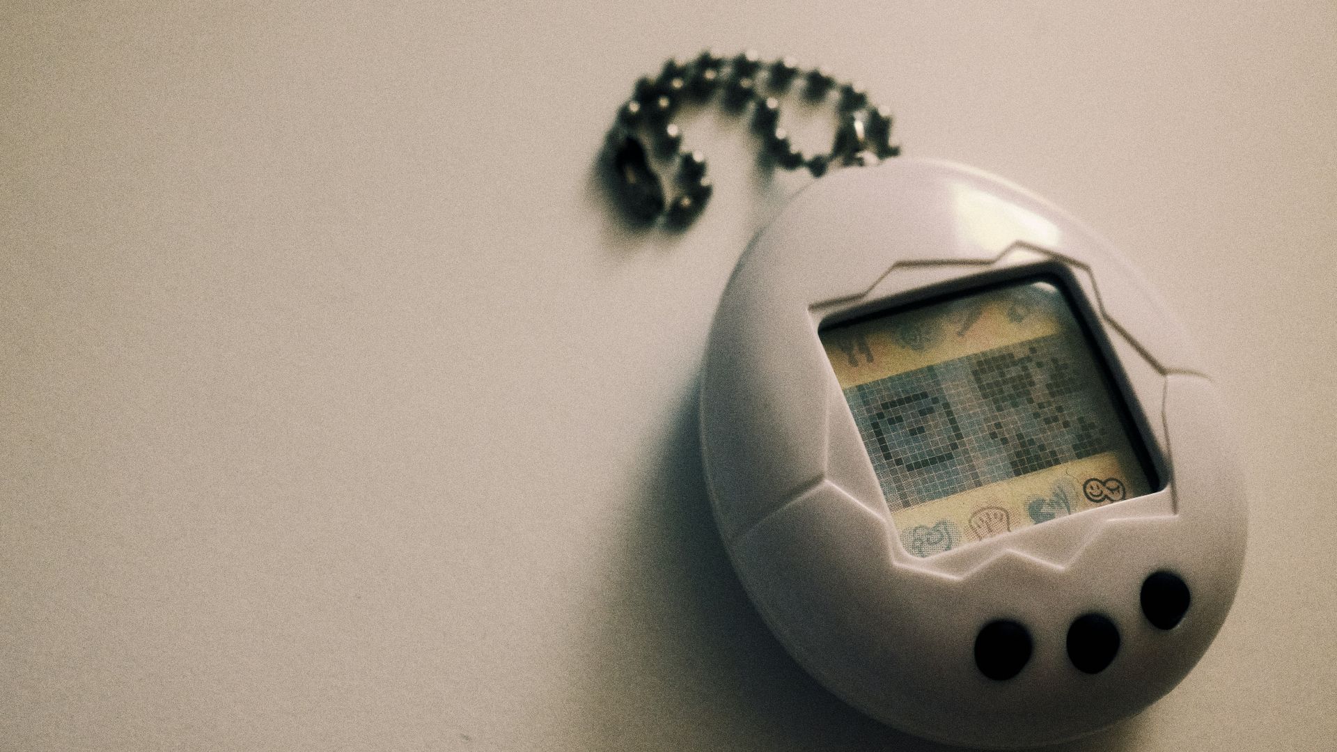 a small electronic device with a chain attached to it