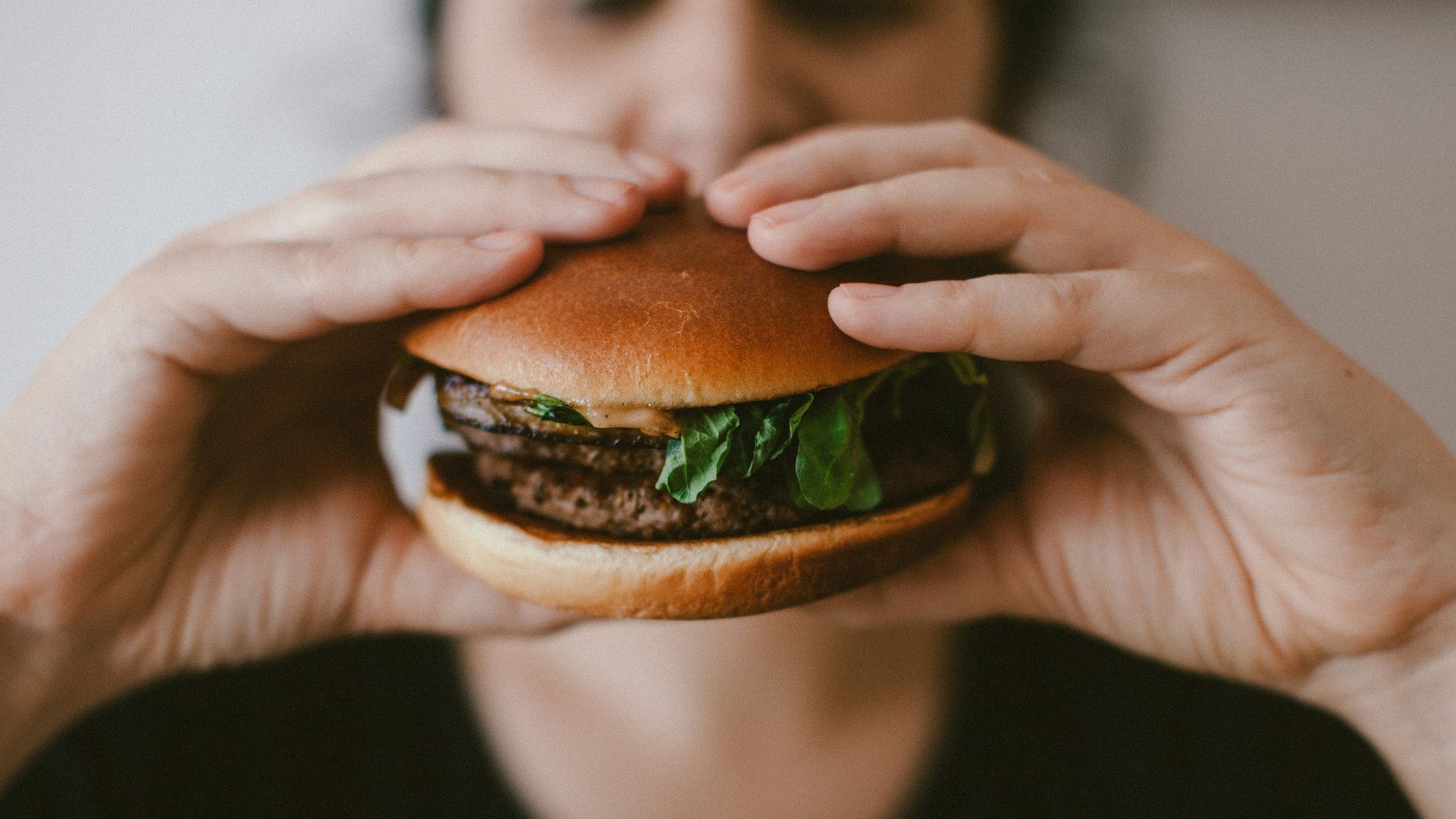 person holding burger