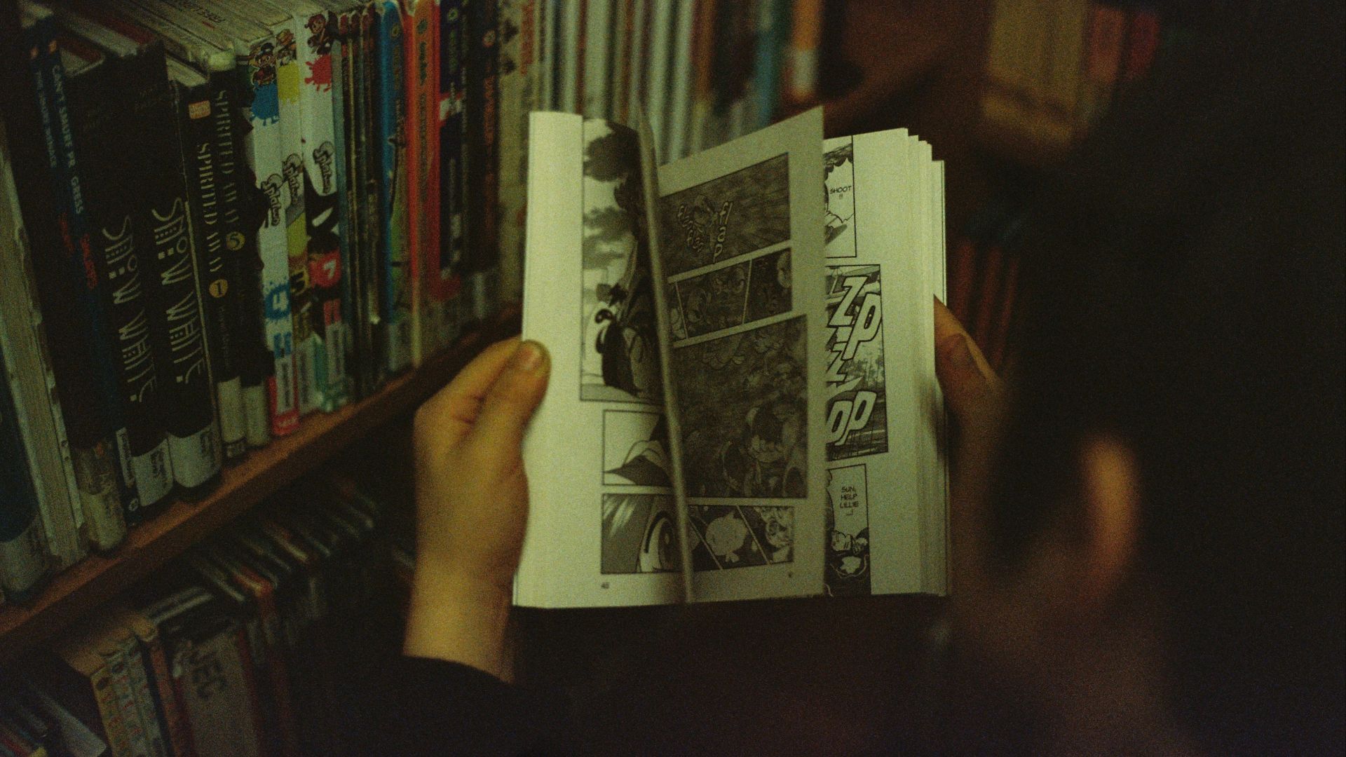 person holding white and black book