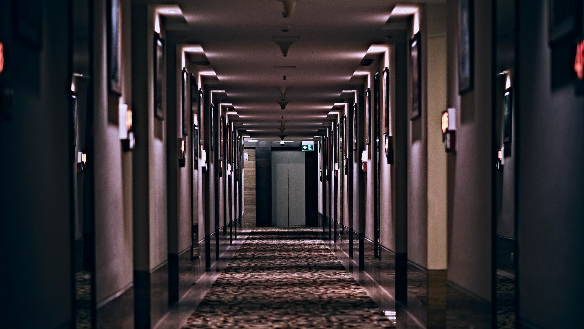 hallway with lights turned on in a hallway