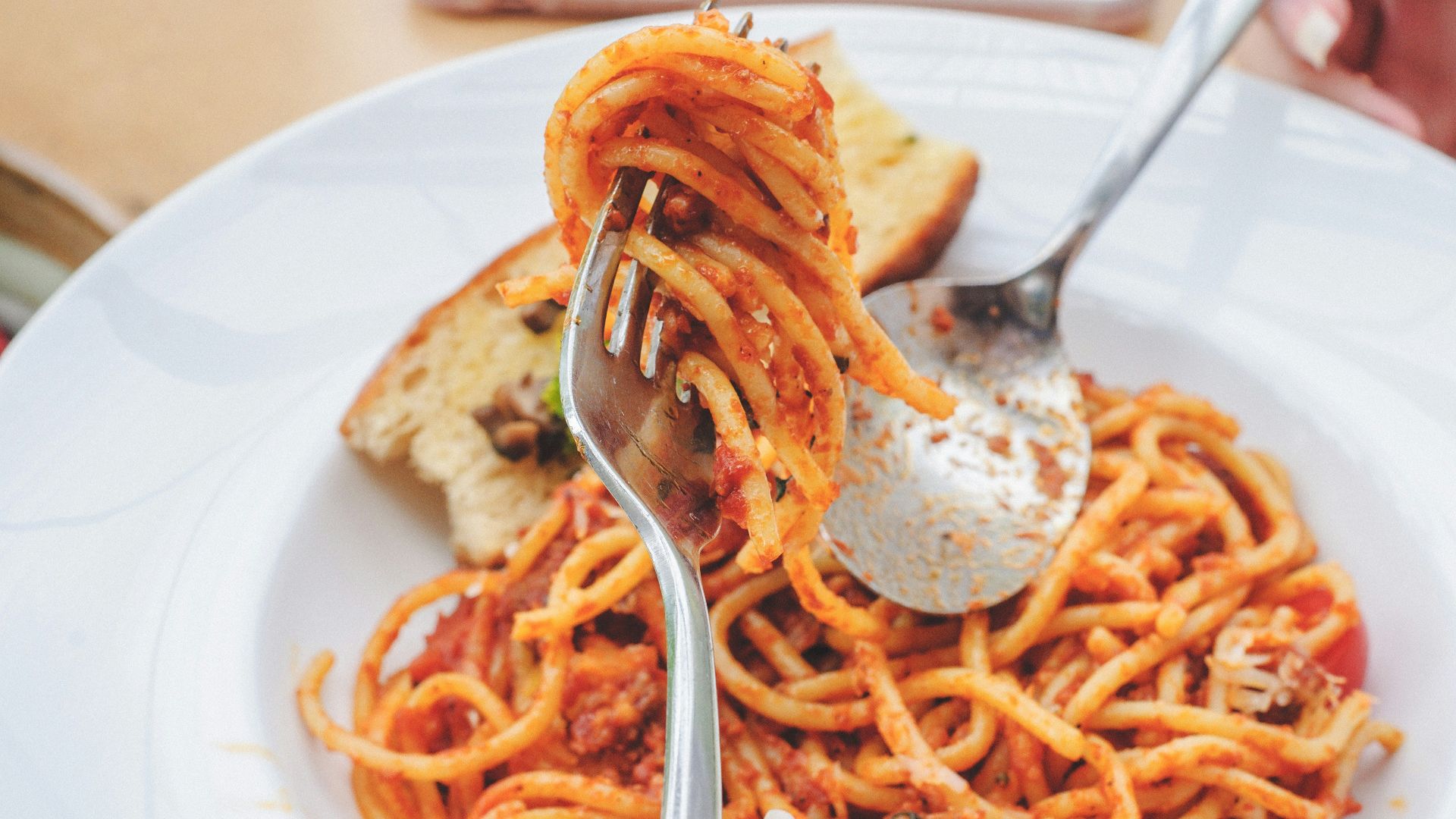 selective focus photography of fork with spaghetti