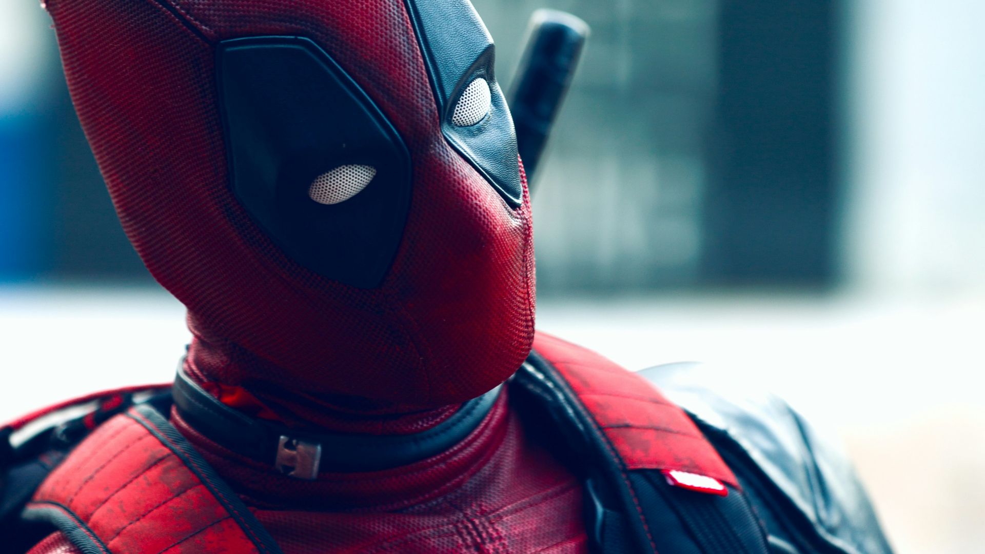 a man in a deadpool costume with a knife in his hand