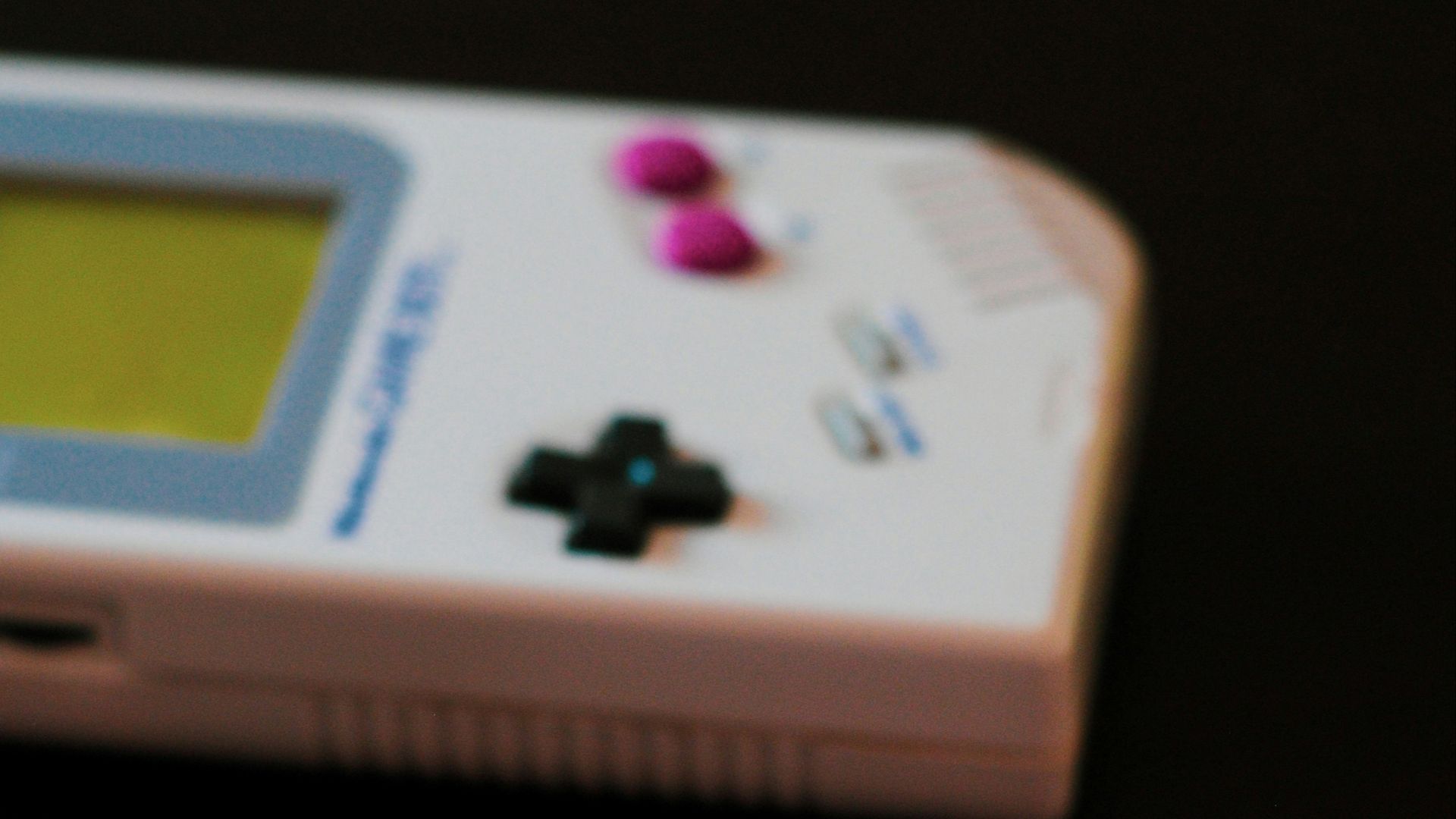 white Nintendo Game Boy controller and two cartridges