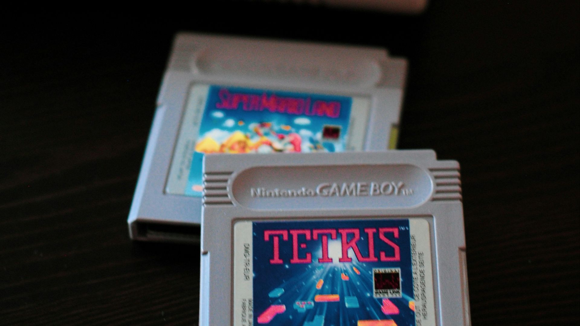 white Nintendo Game Boy controller and two cartridges