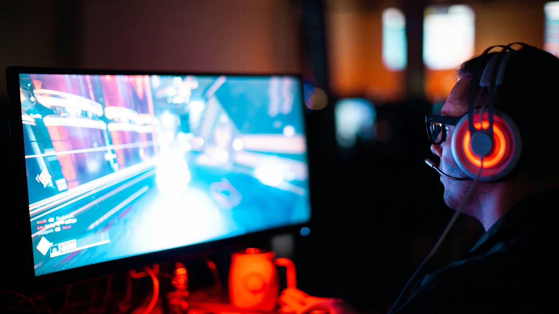 person using computer playing FPS game