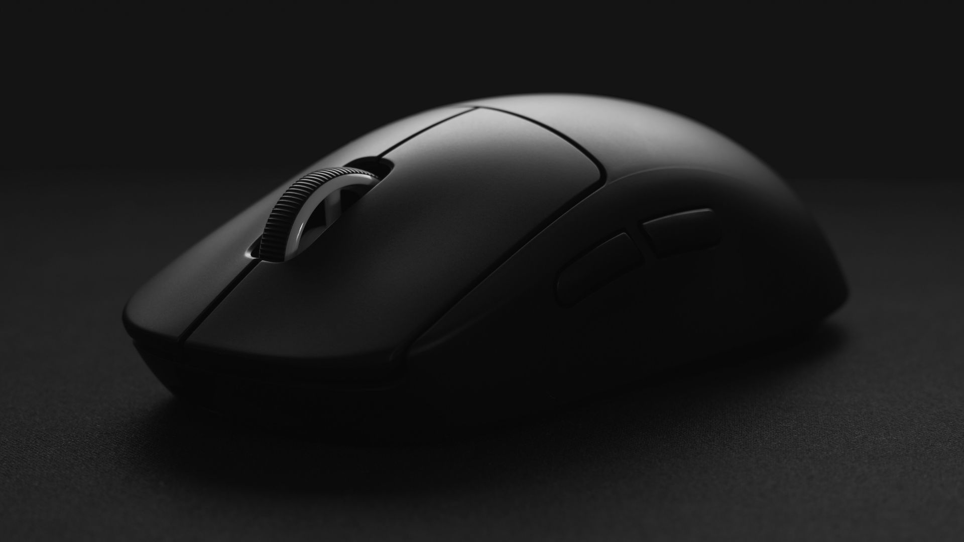 black cordless computer mouse on black surface