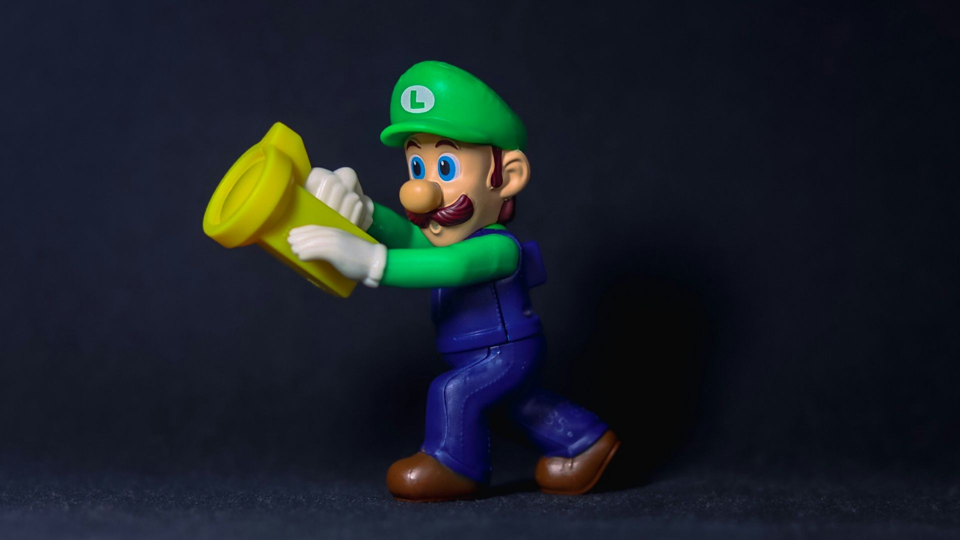 a figurine of a man holding a yellow frisbee