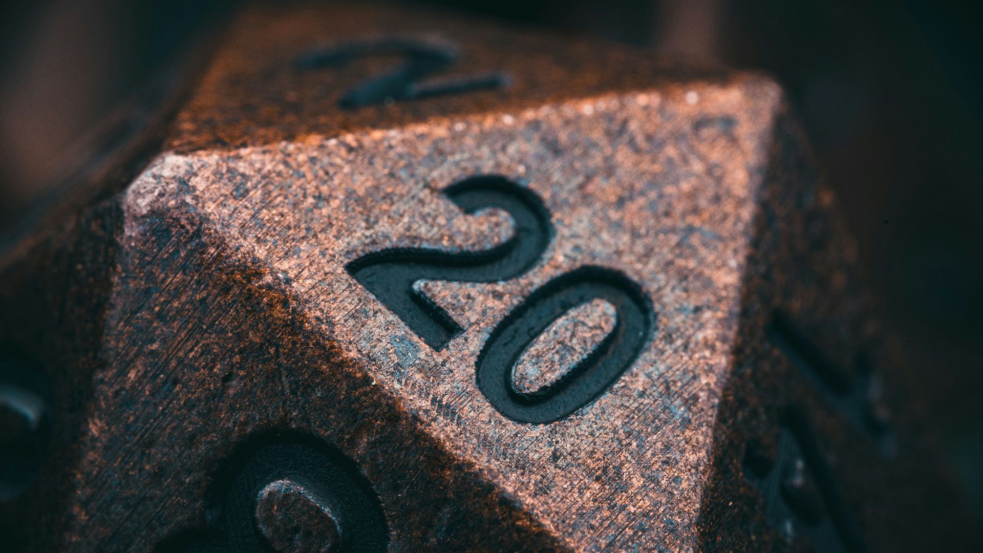 a metal dice with the number twenty on it