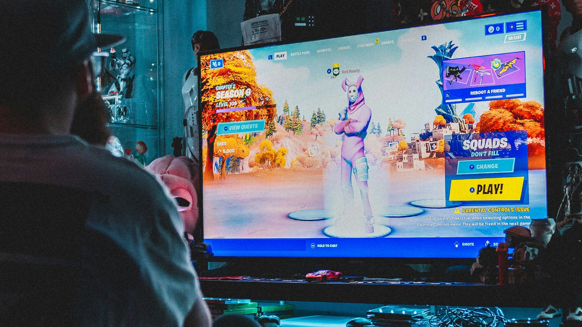 man in red shirt watching tv