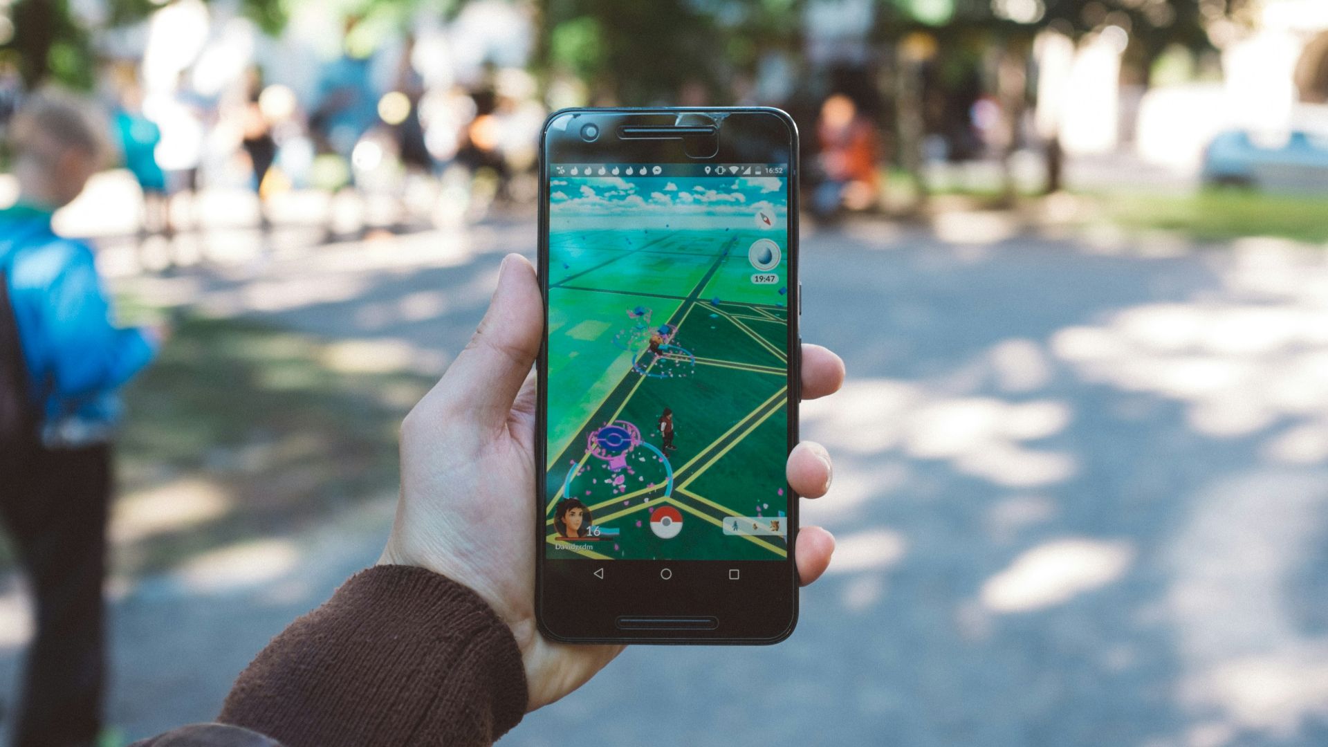 person playing Pokemon Go during daytime