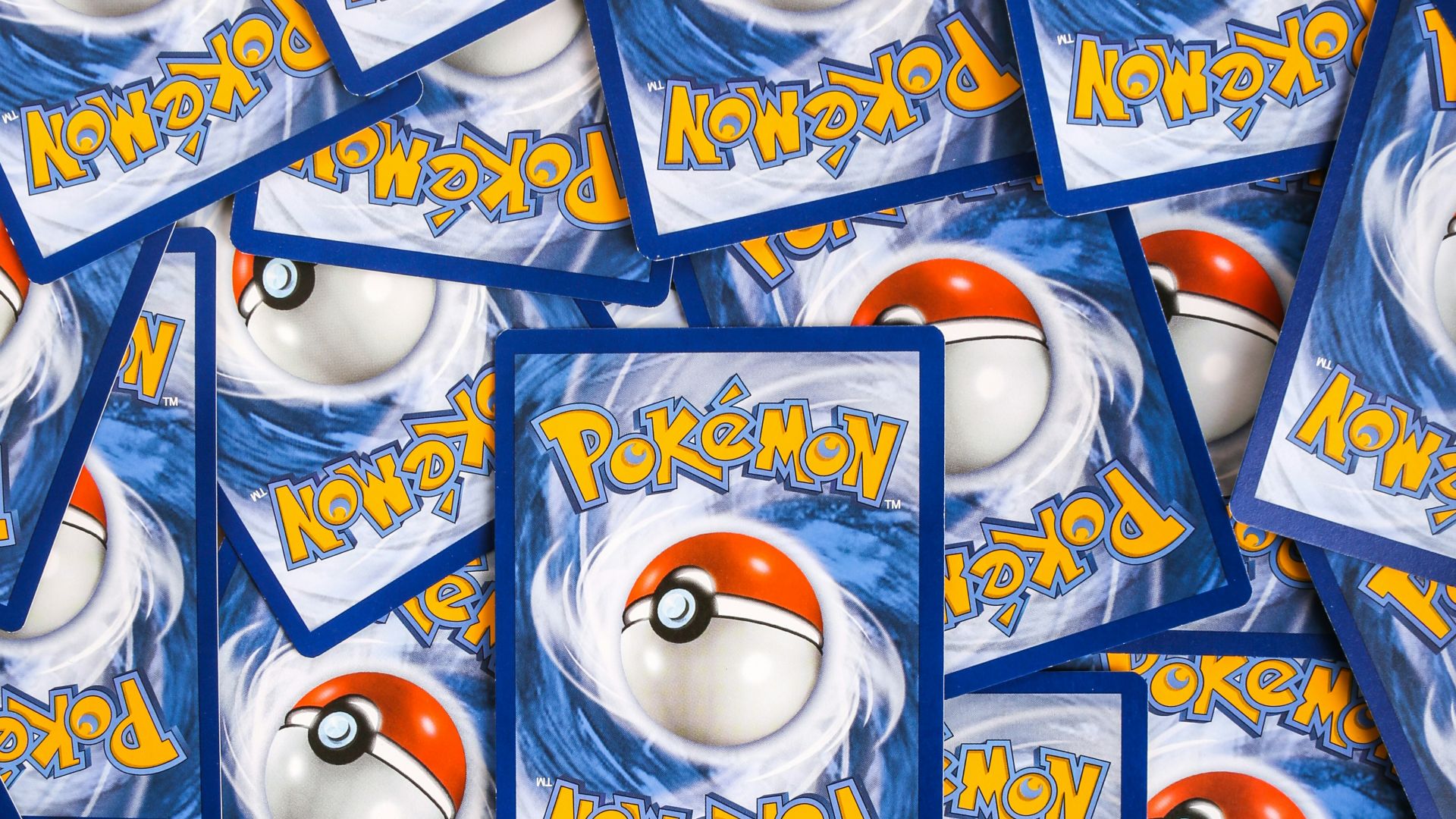 a pile of pokemon trading cards sitting on top of each other