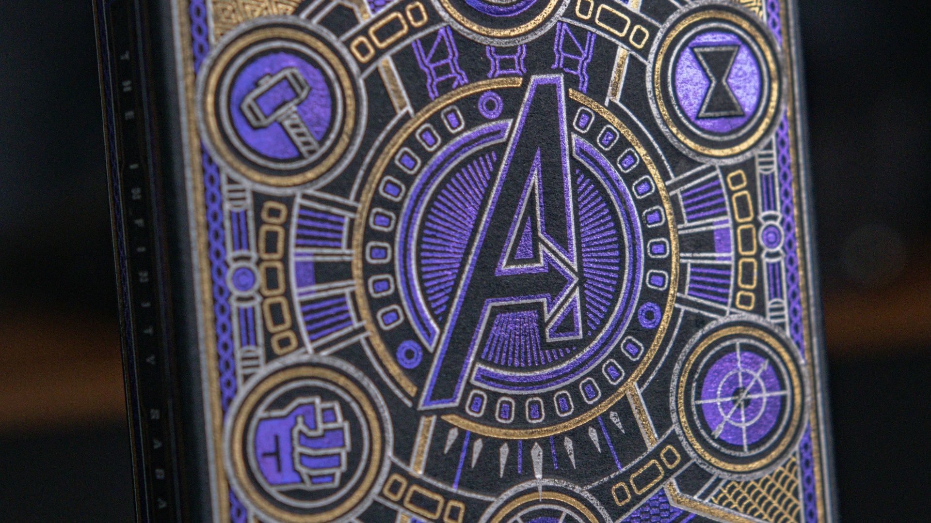 a purple and gold playing card sitting on top of a table