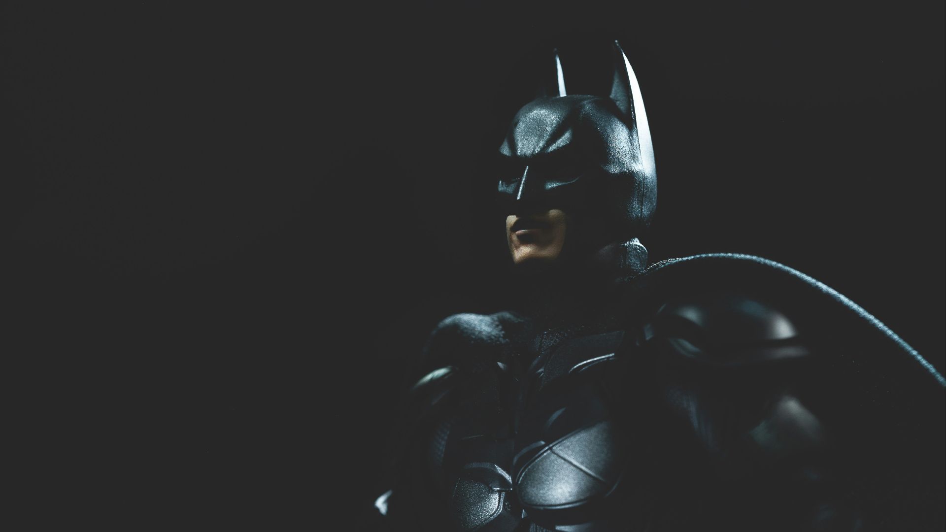 a man in a batman costume holding a bat