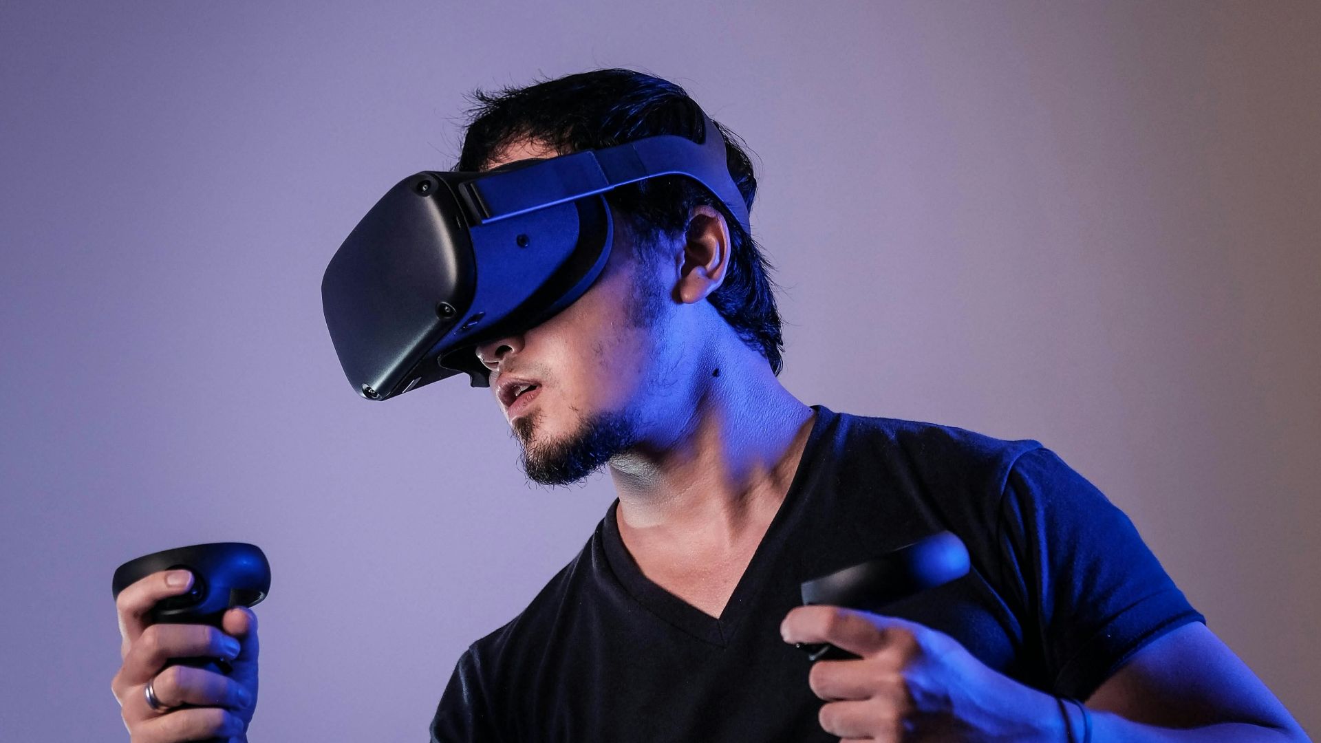 man in black crew neck t-shirt wearing black sunglasses holding black smartphone