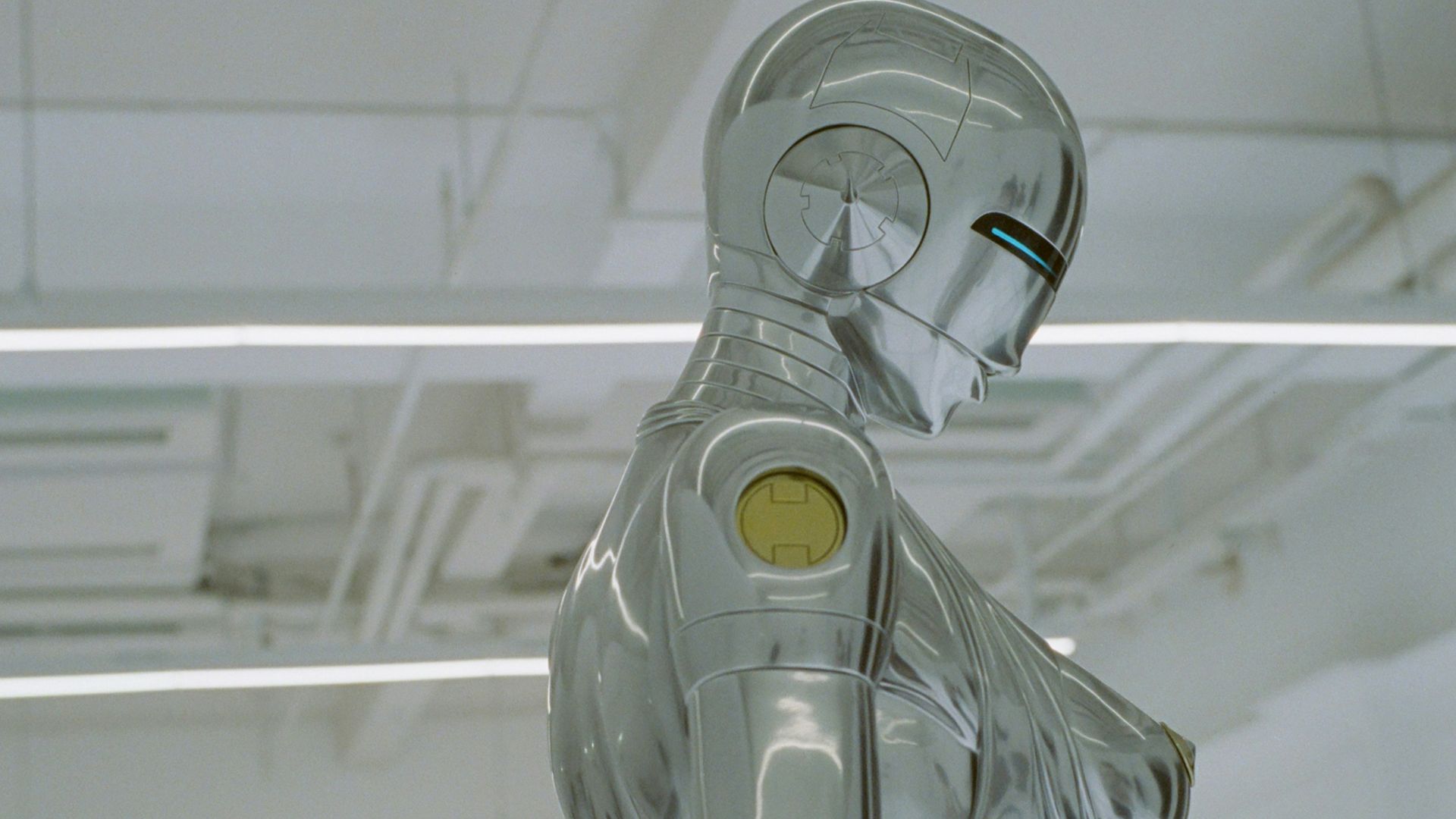 a robot sitting on a chair in a room