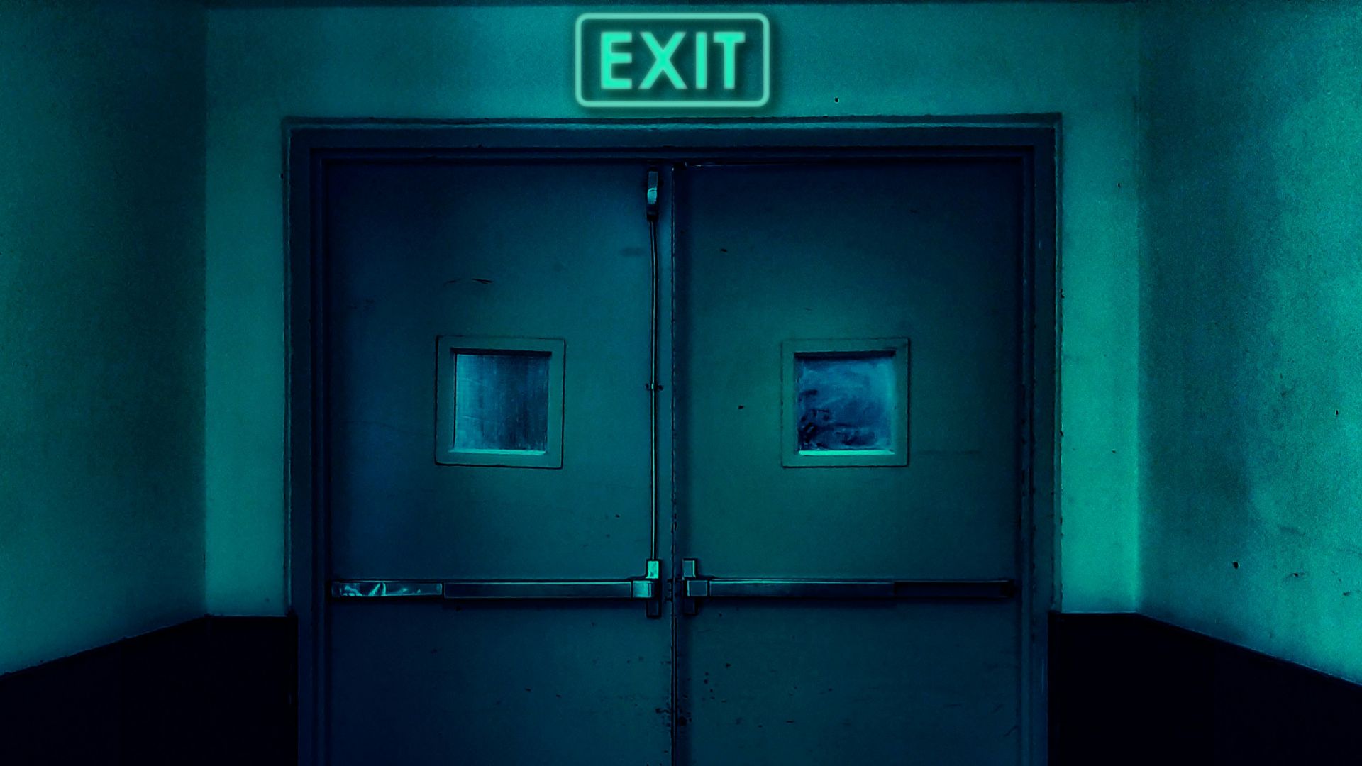 an exit sign above a door in a dark room
