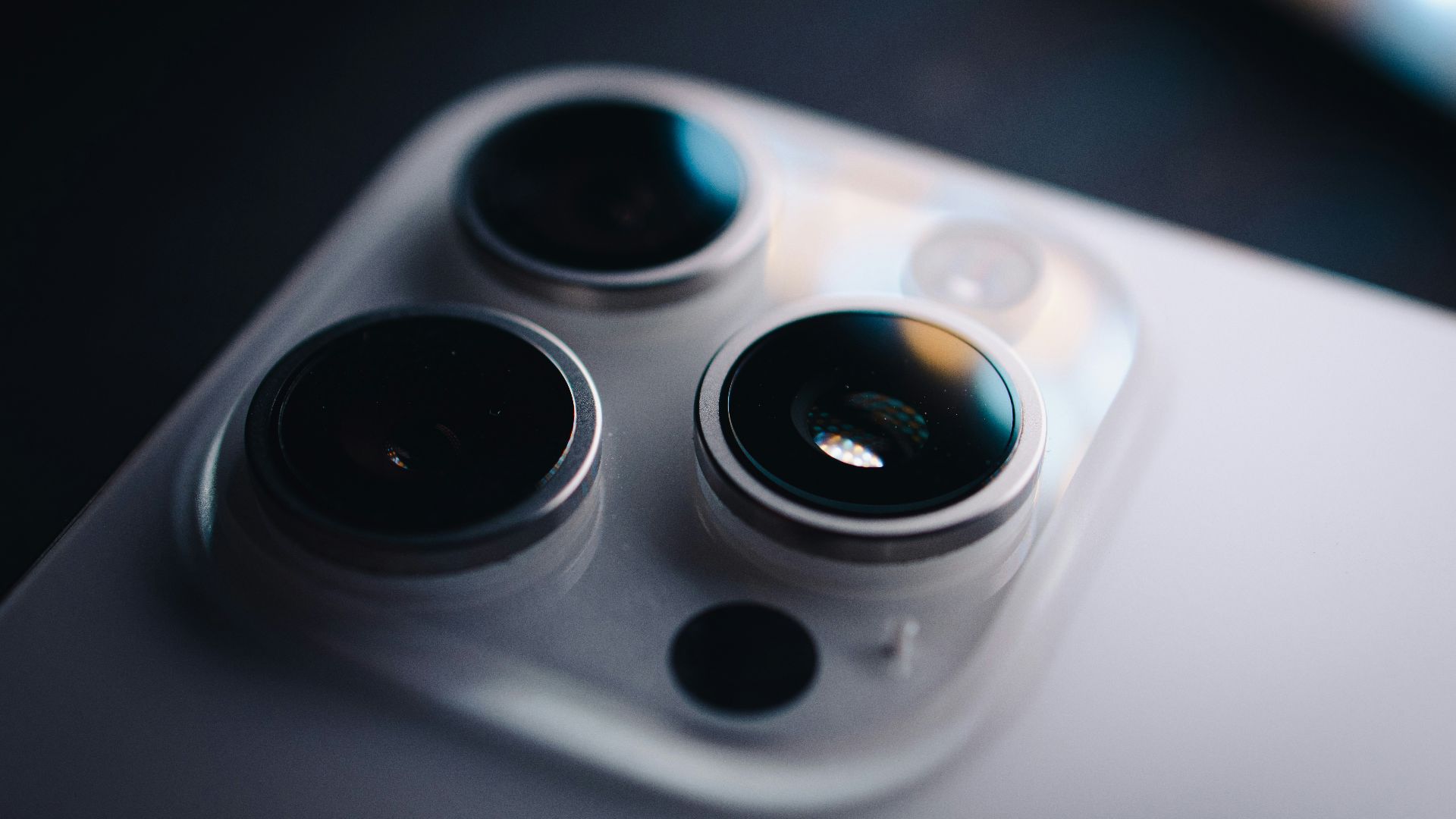 Close-up shows the triple-lens camera on a phone.