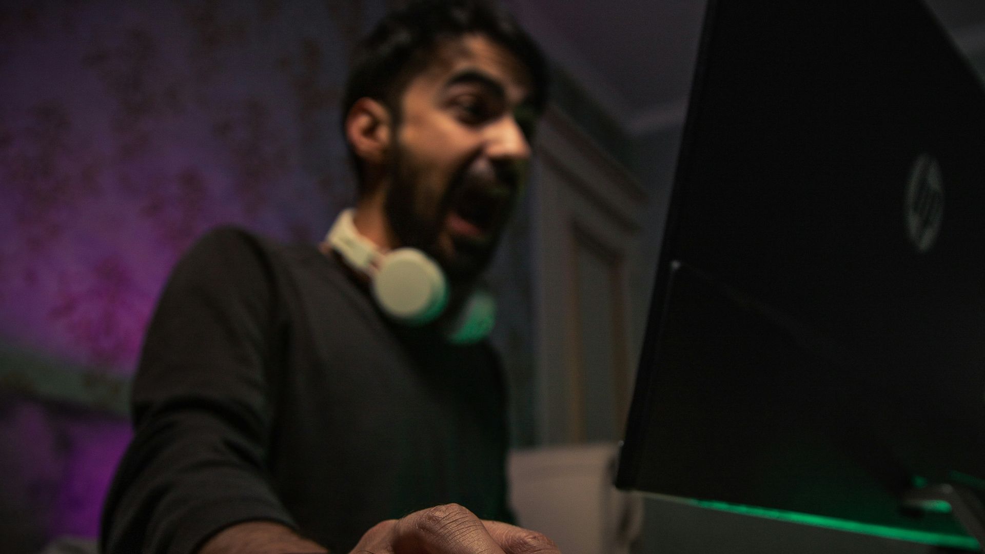 man in black long sleeve shirt holding black laptop computer