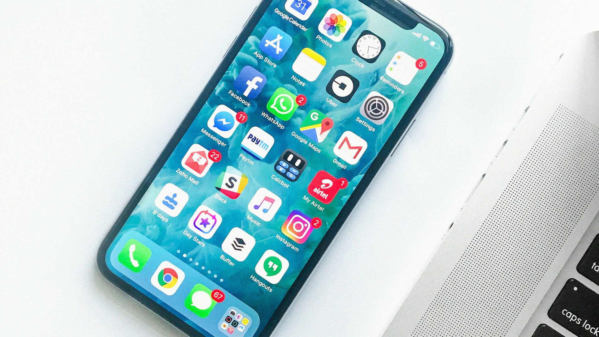 white smartphone near laptop