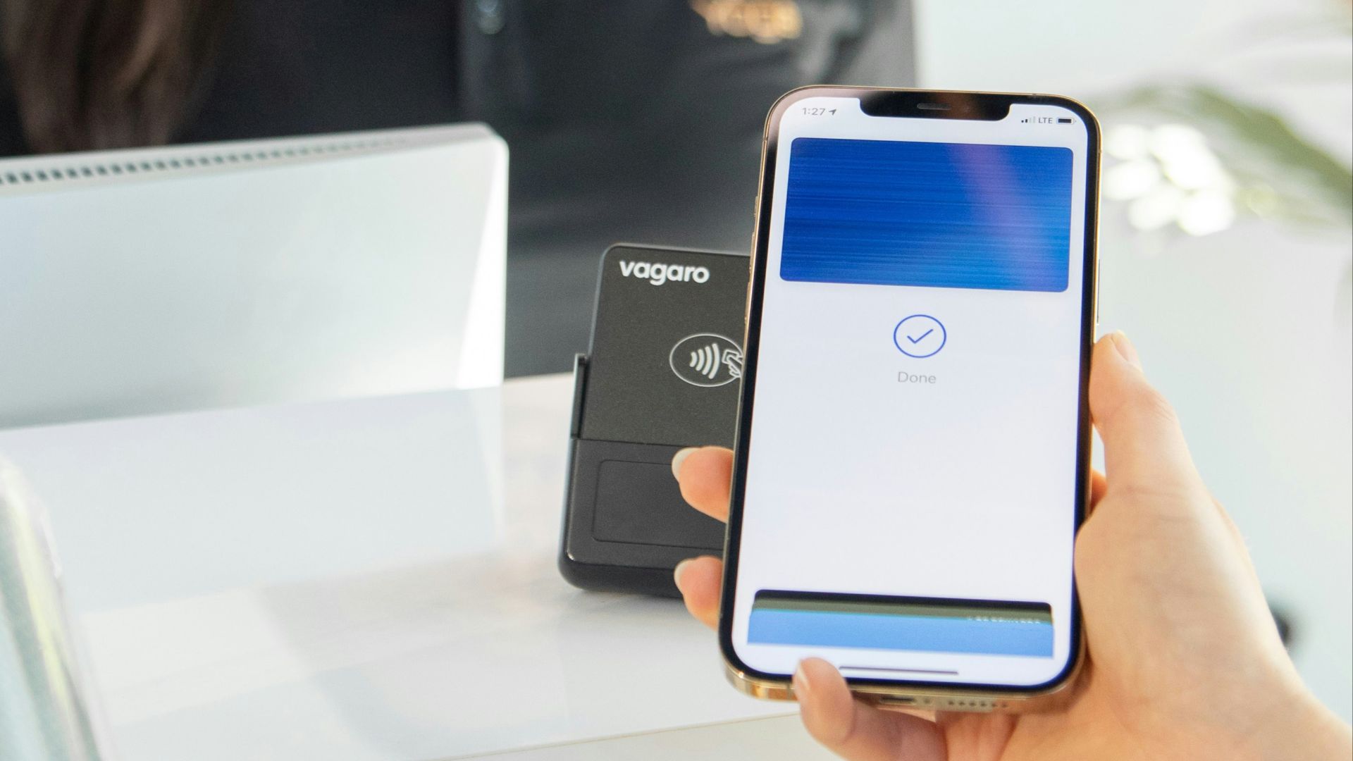 a woman is showing a cell phone to another woman