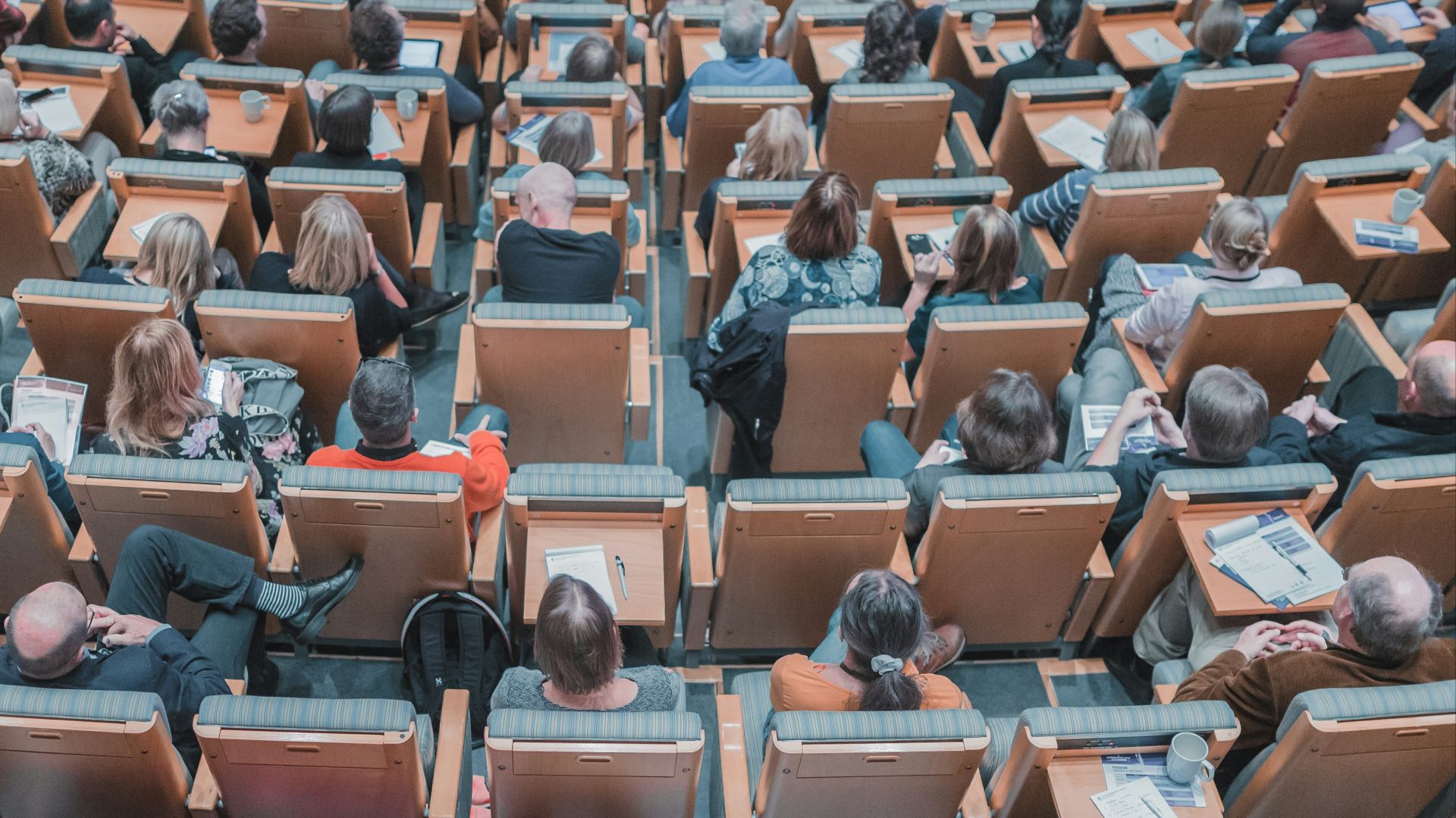 high-angle photography of group of people sitting at chairs