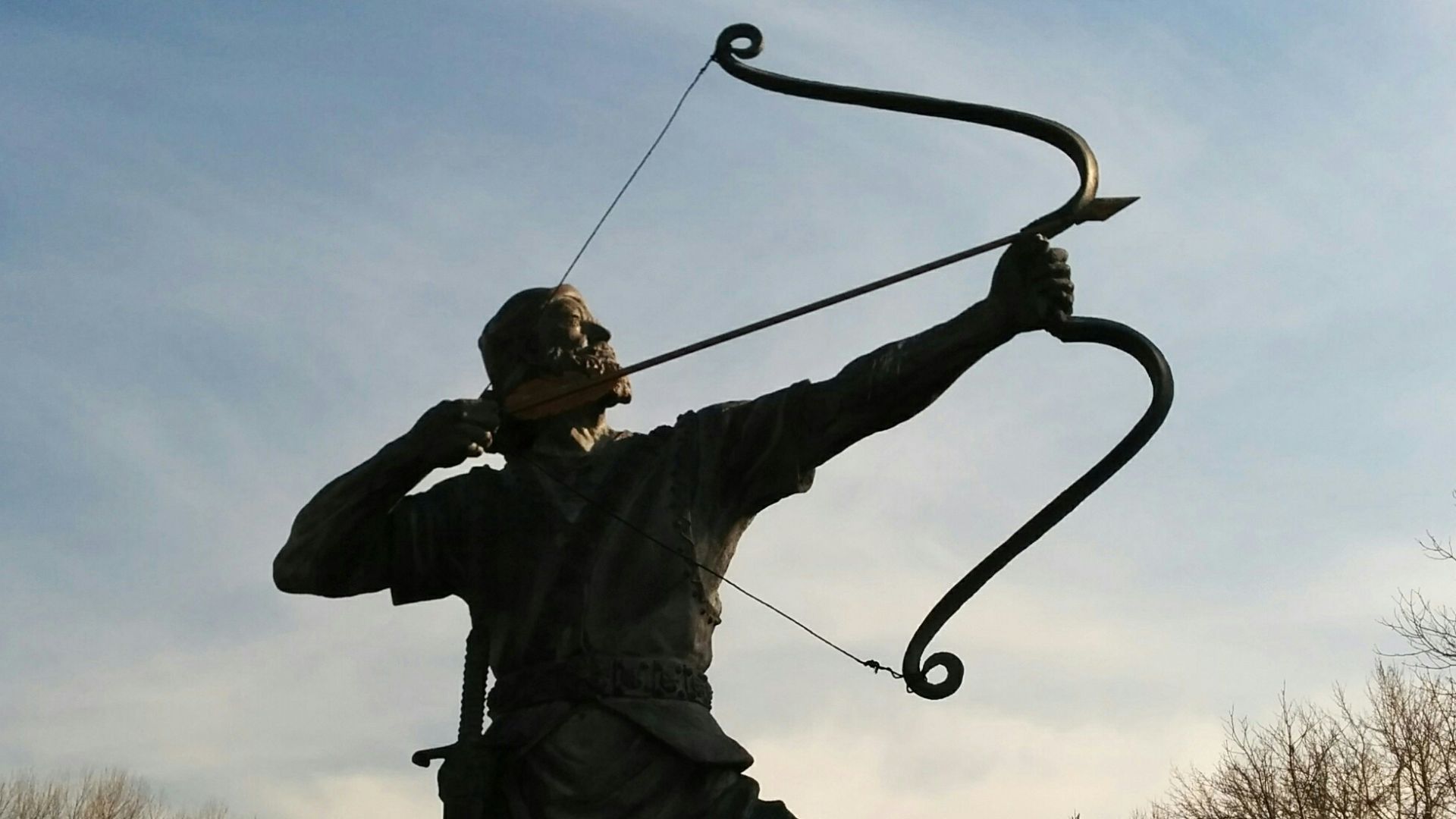 man holding archer statue