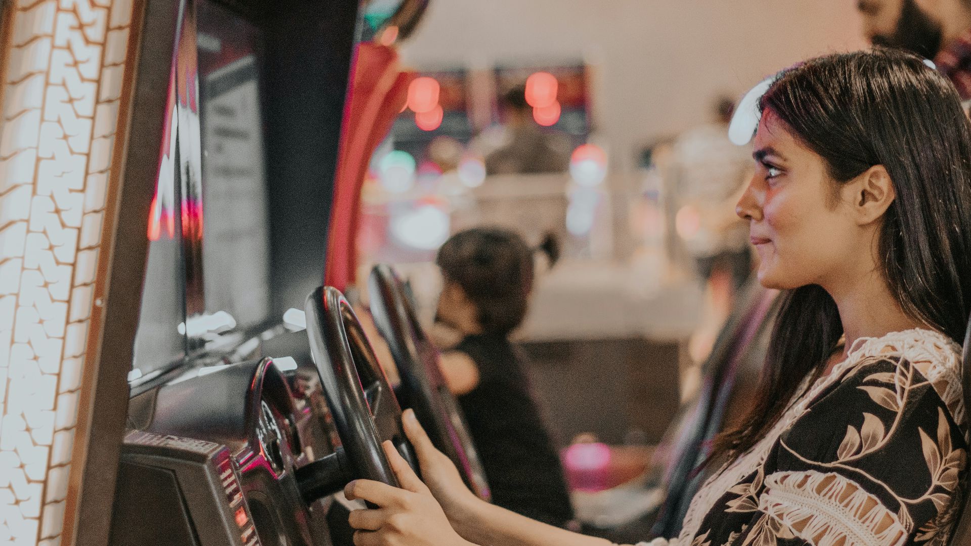 woman in black and white floral long sleeve shirt using smartphone