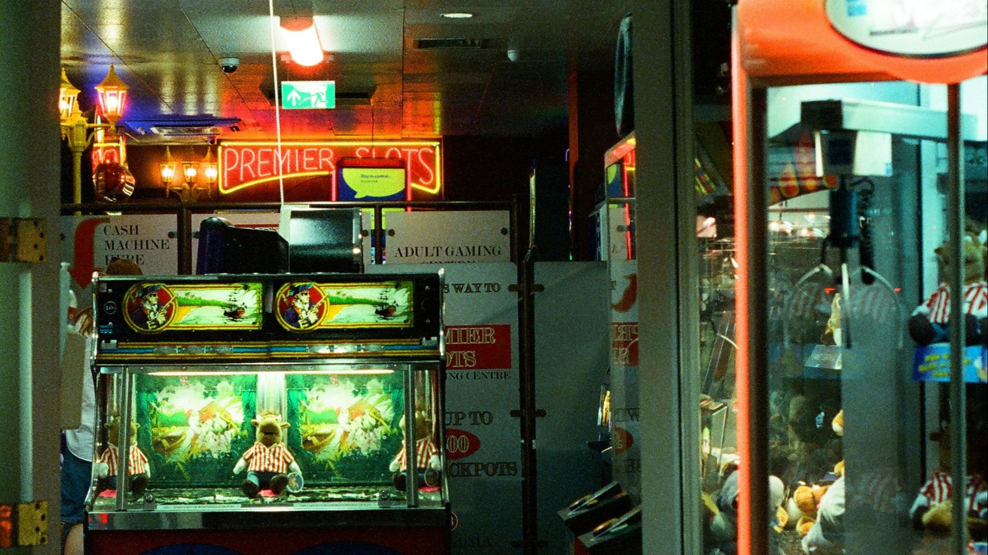 Amusements arcade entrance with neon signs and games.
