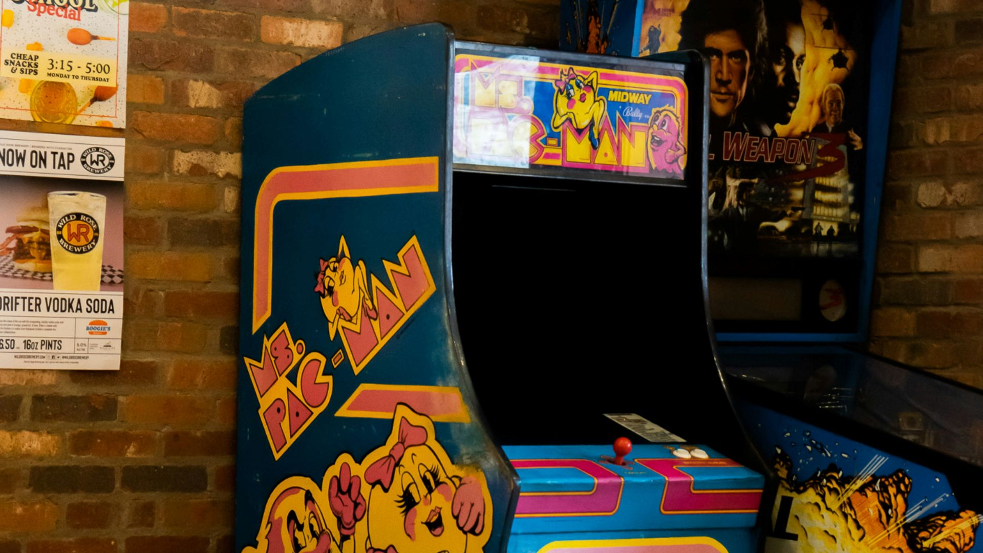 a video game machine sitting next to a brick wall