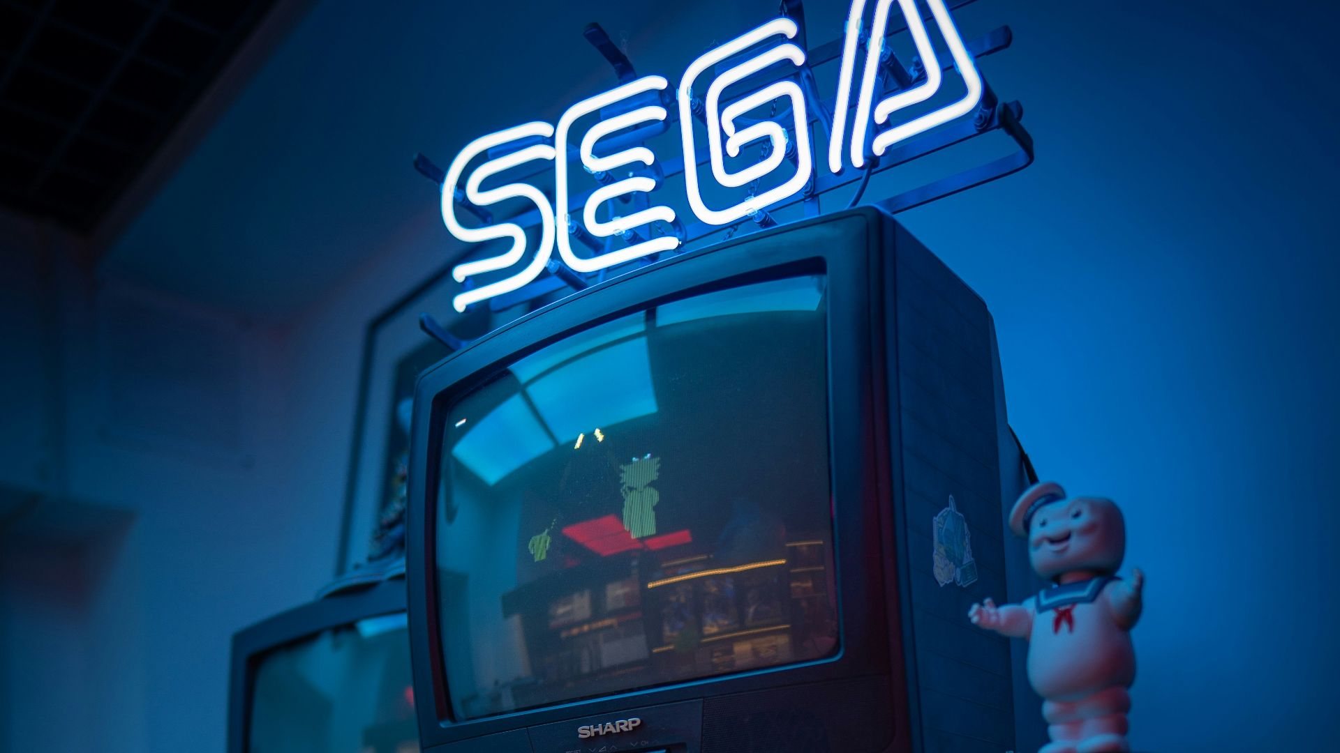 black crt tv turned on on brown wooden tv rack