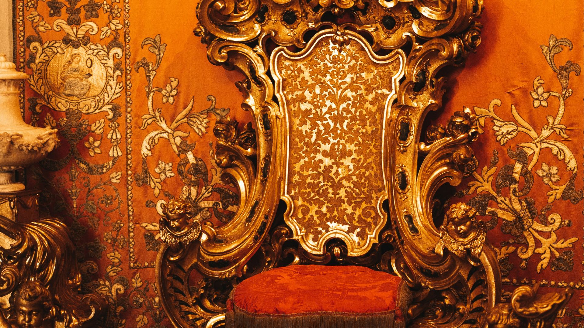 a golden throne with a red seat in a room
