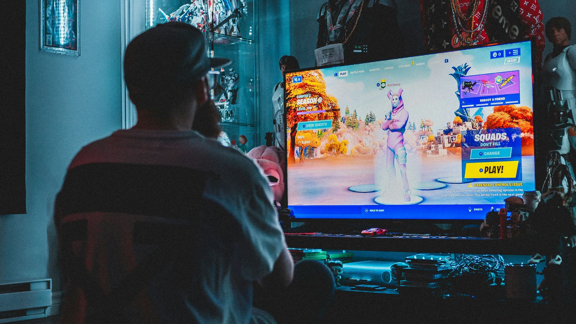 man in red shirt watching tv