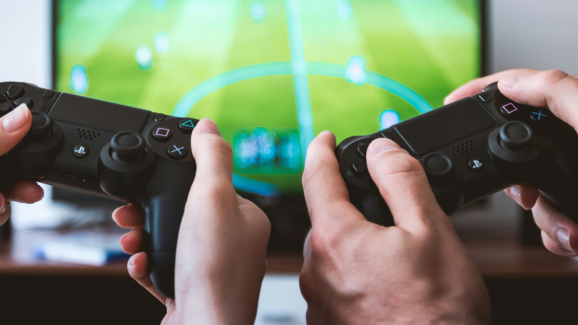 two people playing Sony PS4 game console