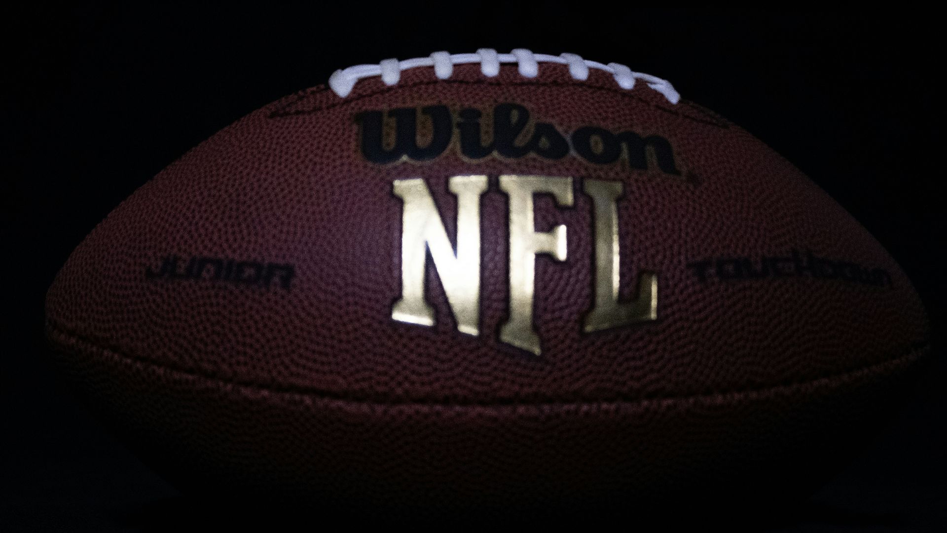 a close up of a football on a black background