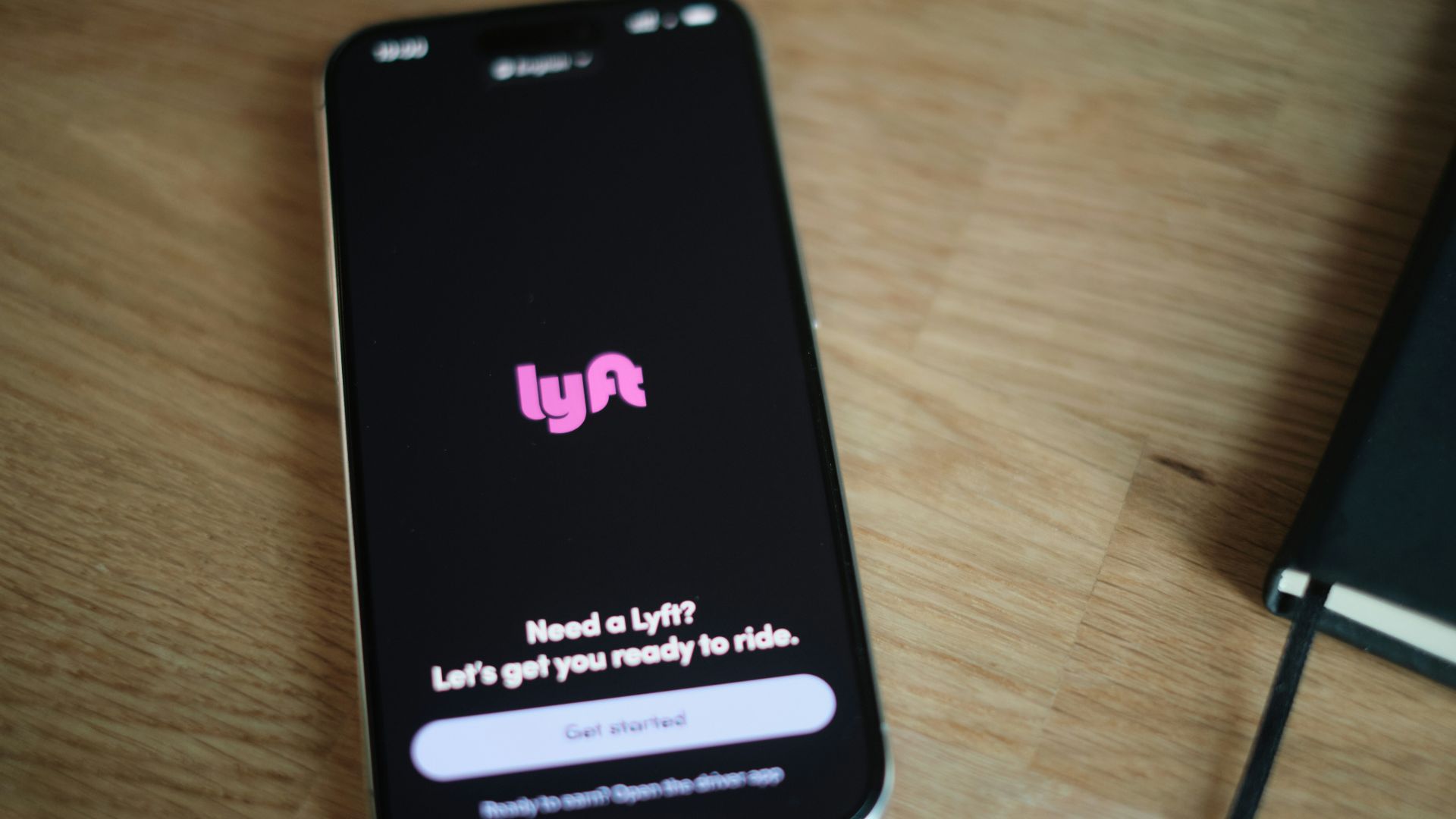 A cell phone sitting on top of a wooden table