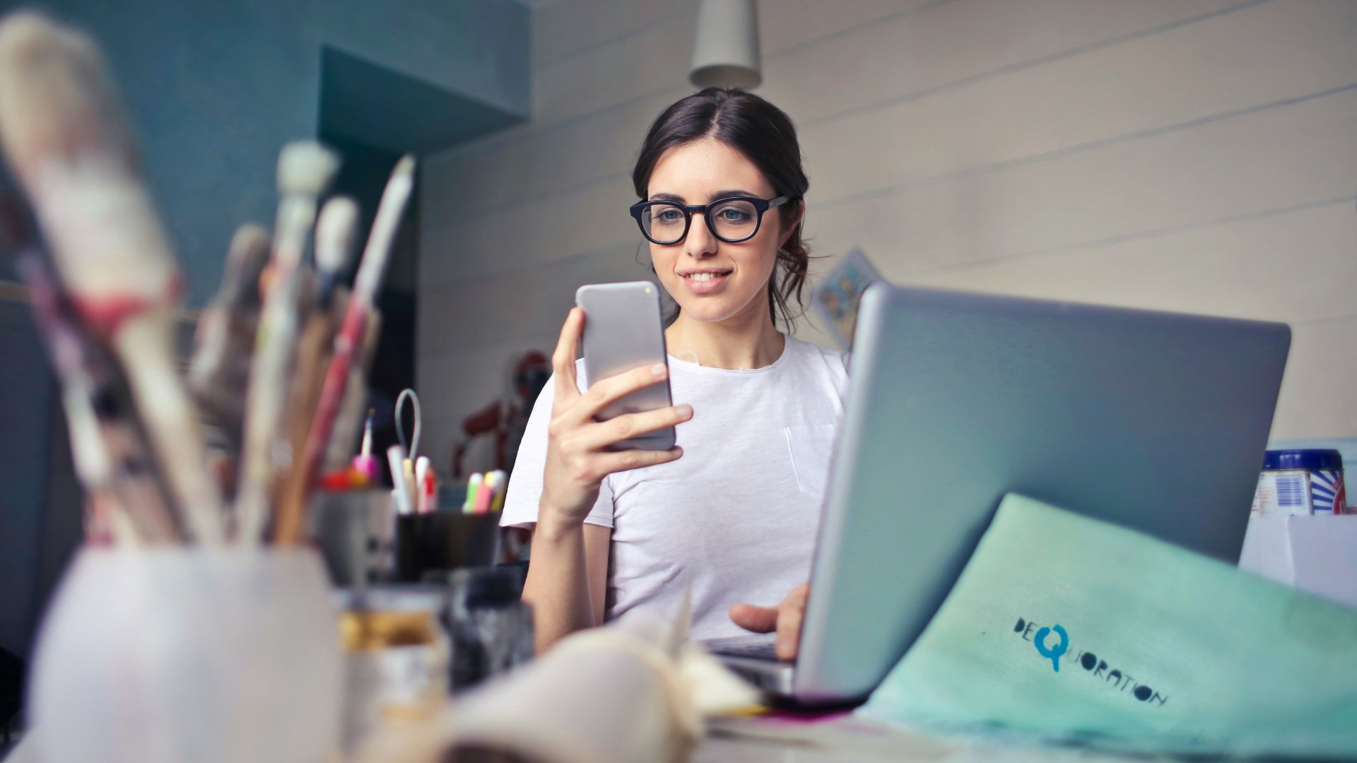 woman in white shirt using smartphone