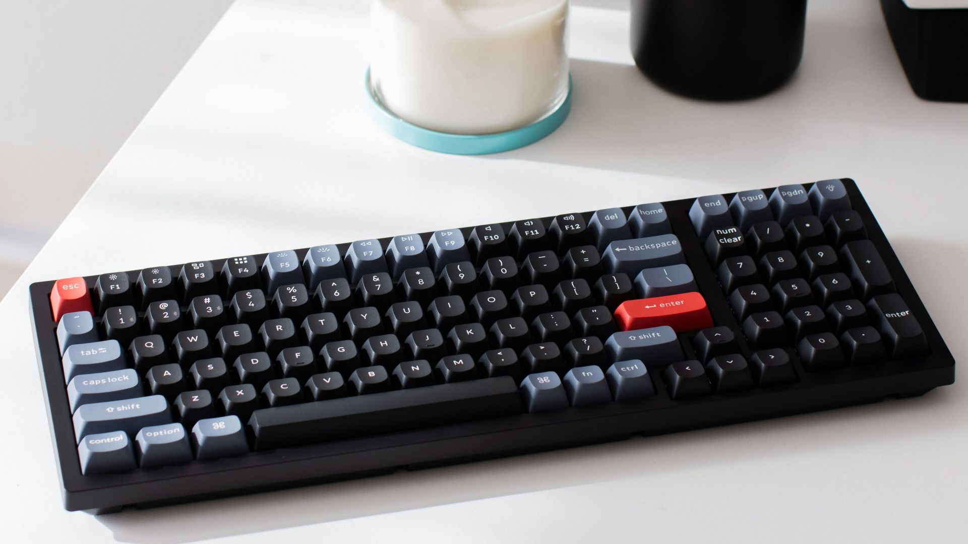 a computer keyboard sitting on top of a white desk