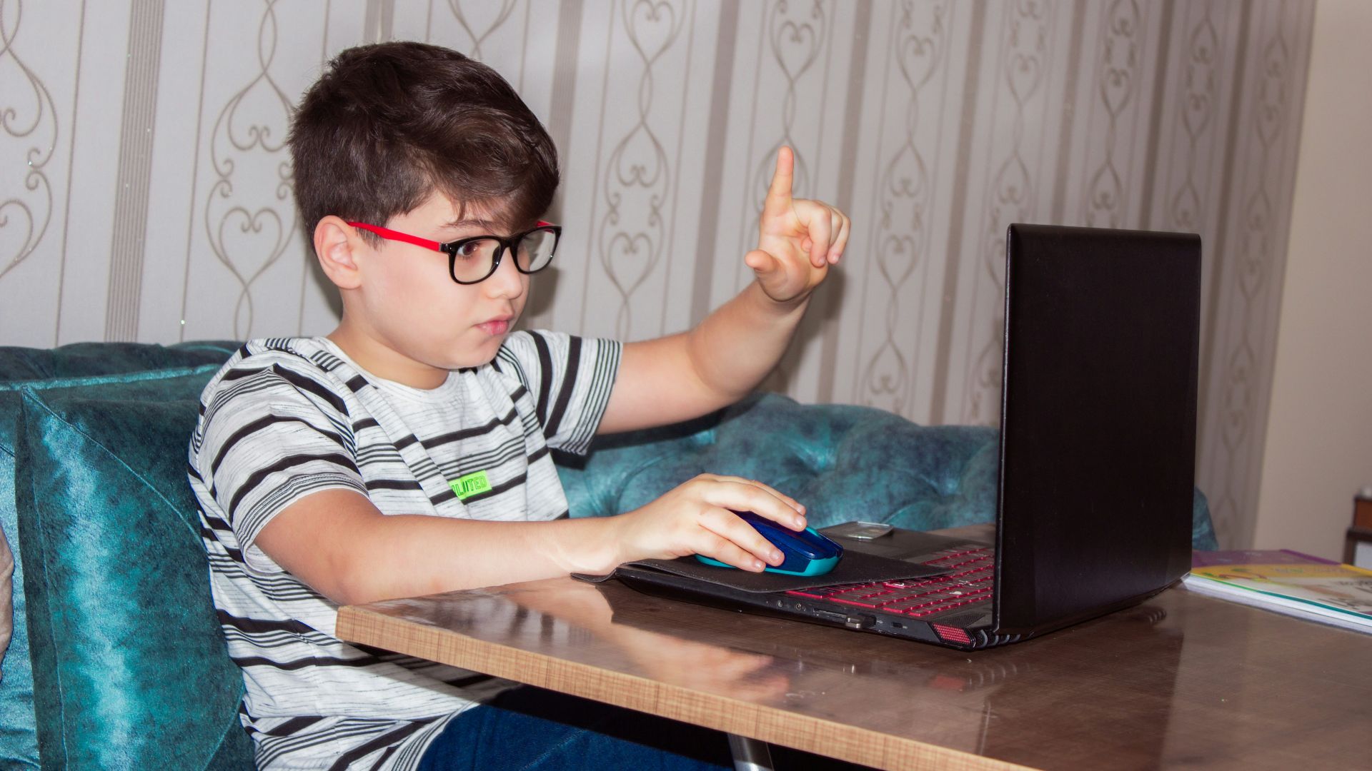 man in black and white stripe shirt using black laptop computer