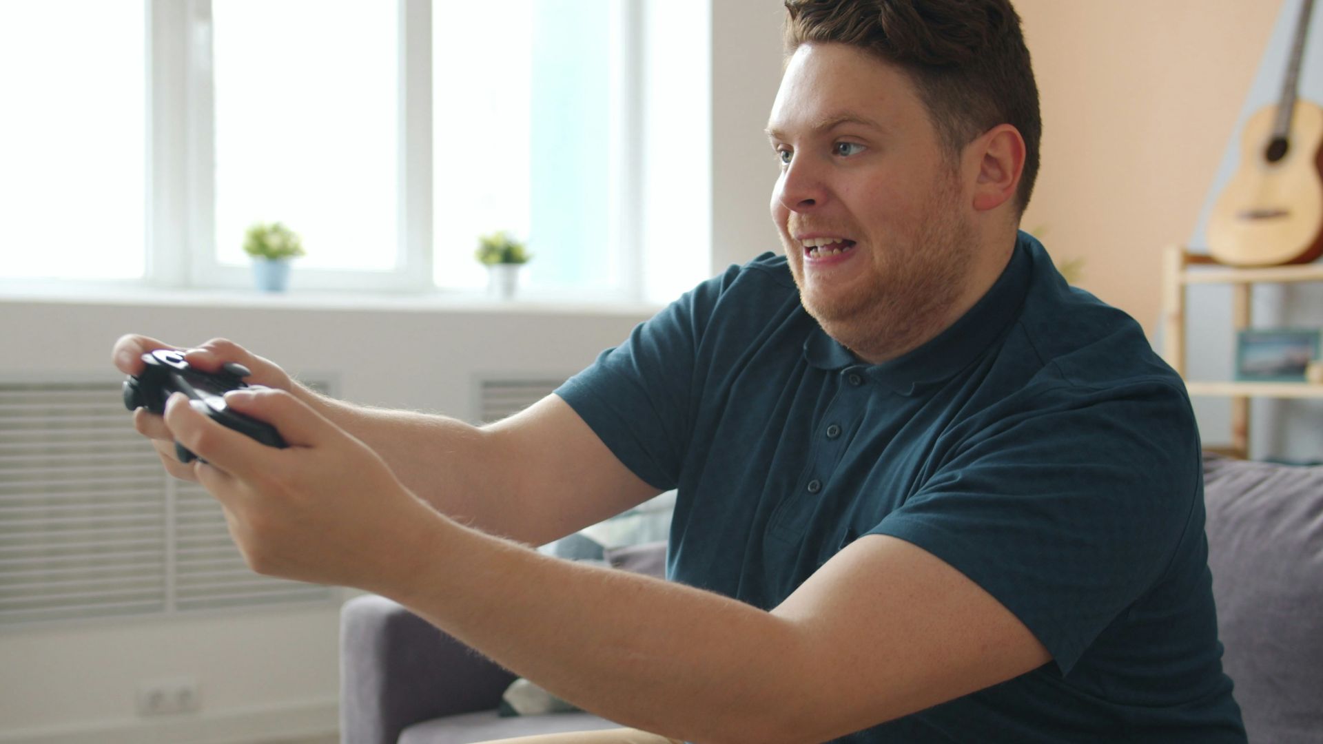 Man playing video games on a couch