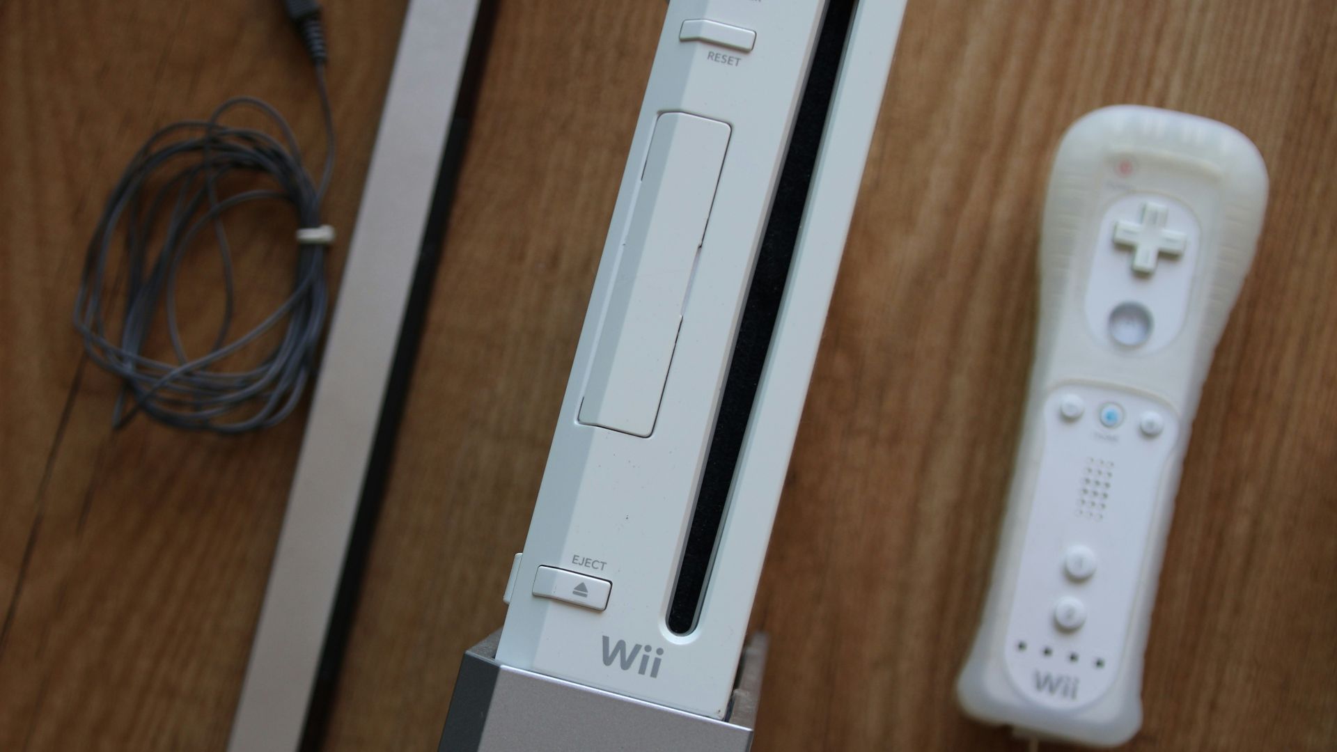 a nintendo wii game system sitting on top of a wooden table