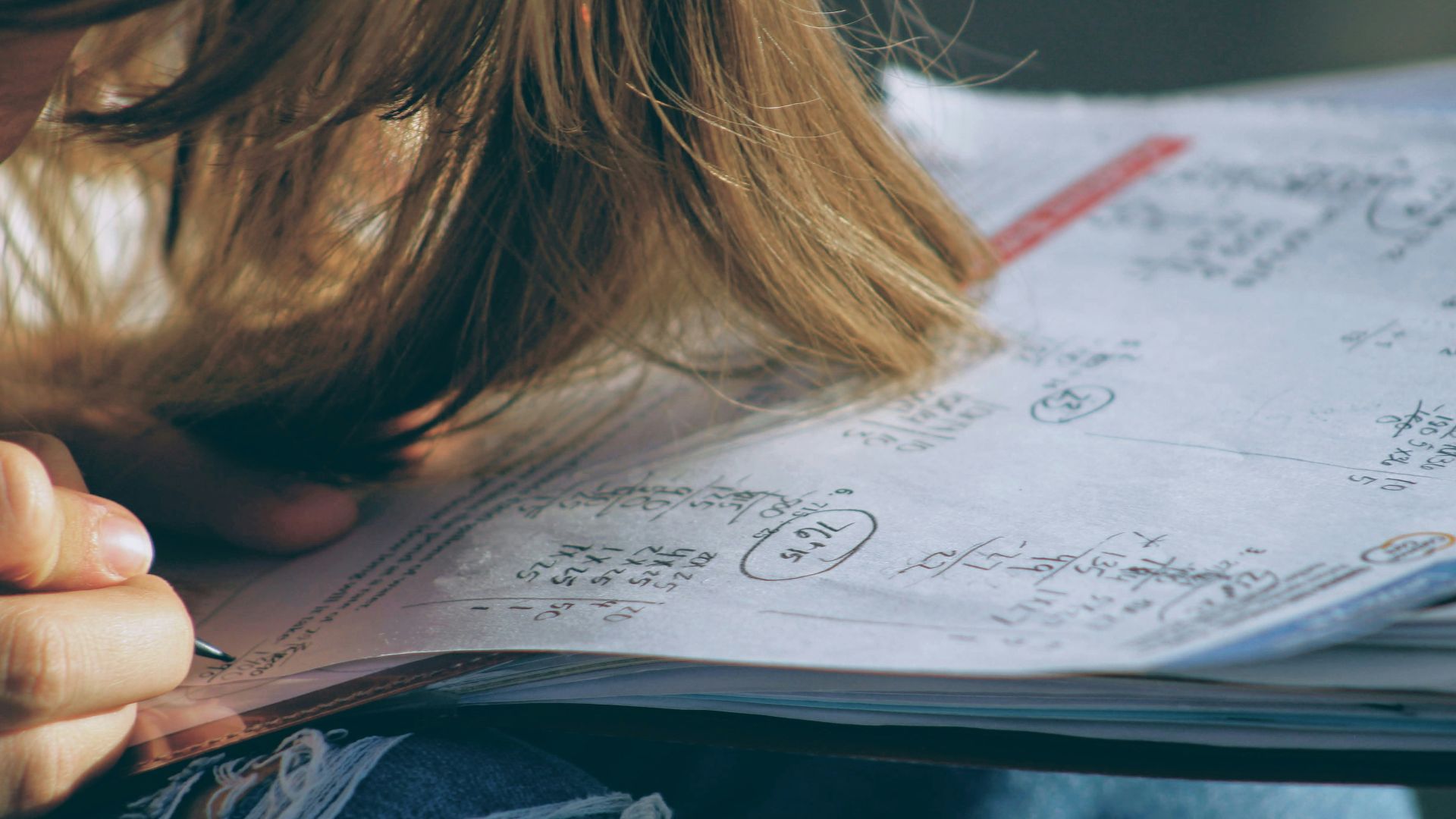 woman in blue denim jacket holding white paper