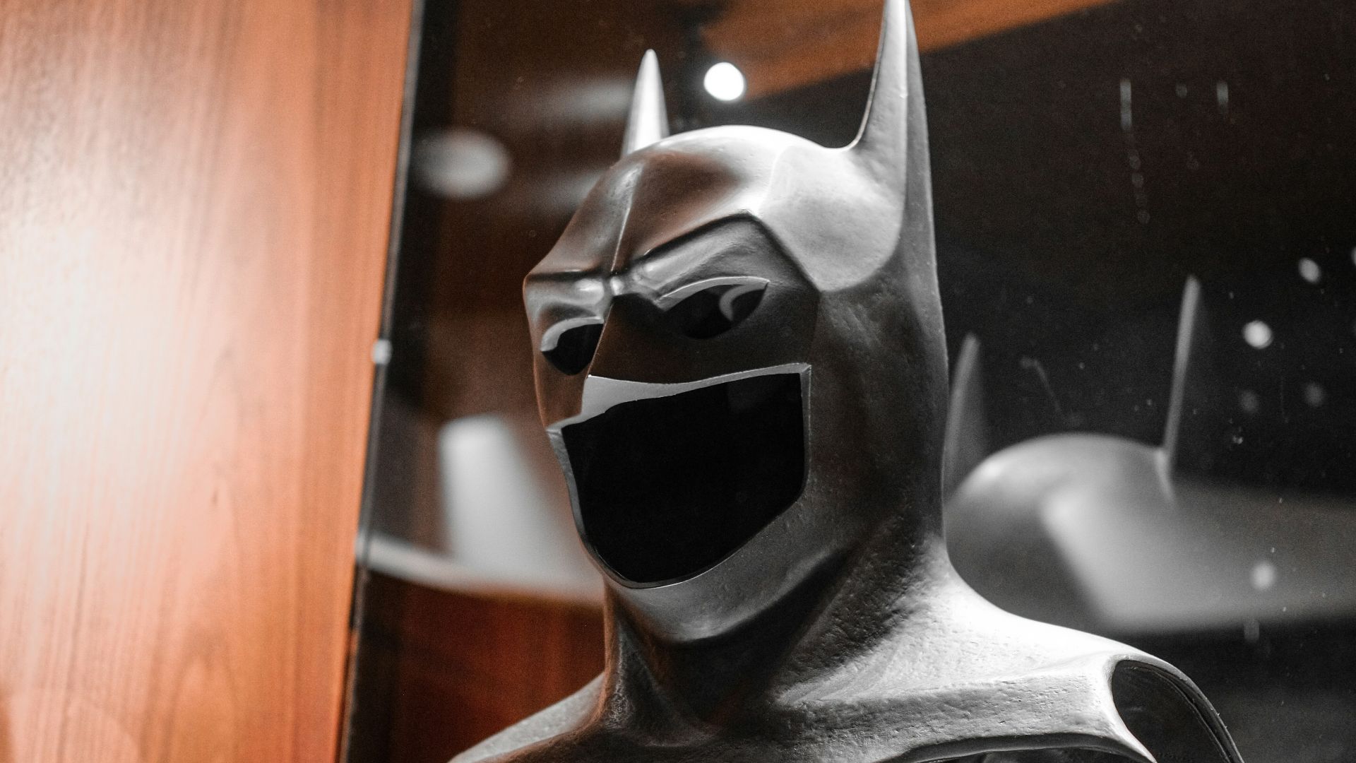 A picture of a batman statue on display