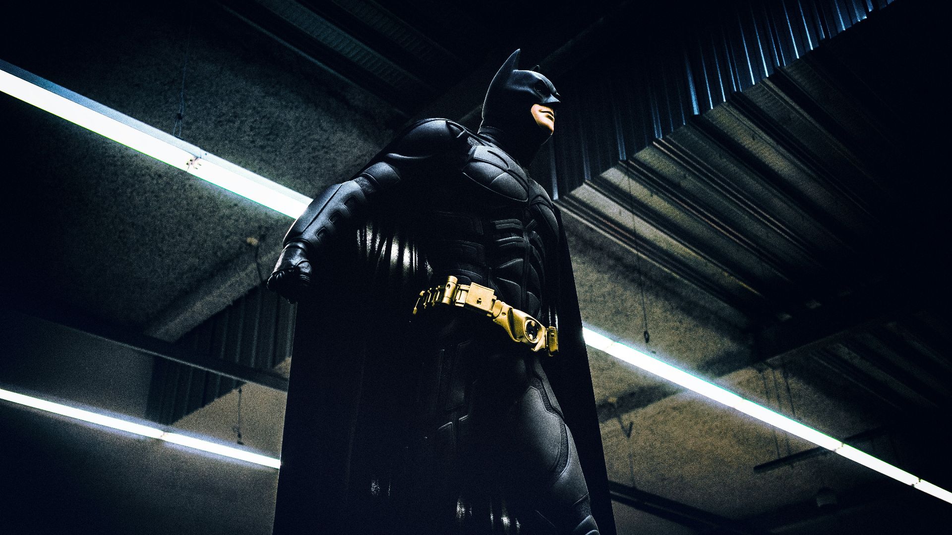 Batman standing under steel roof