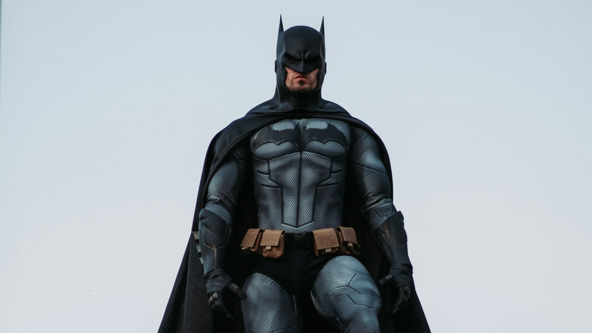 man in black jacket and pants standing on roof