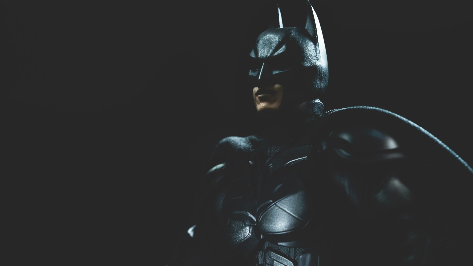 a man in a batman costume holding a bat