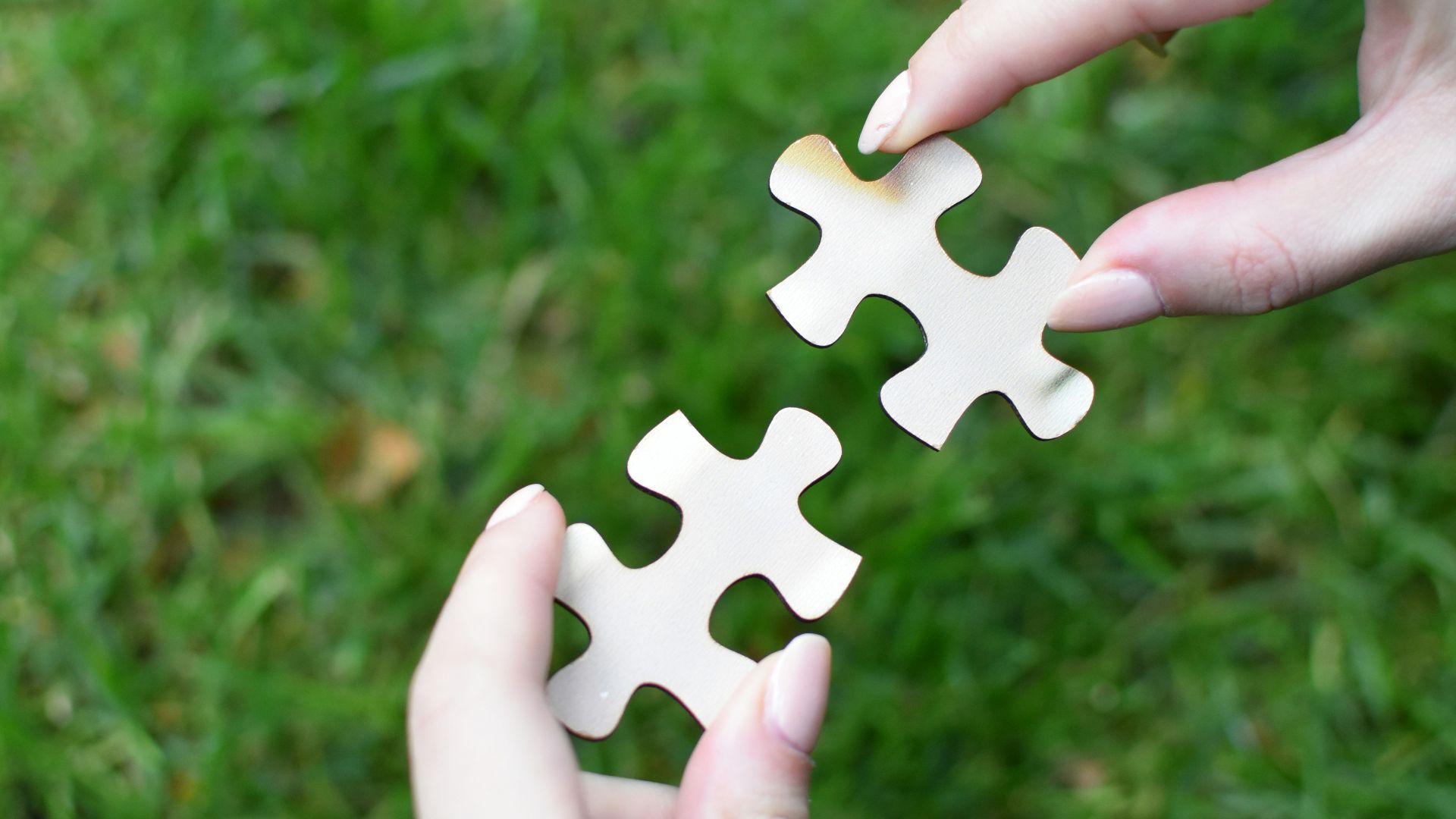 a person holding a piece of a puzzle in their hands